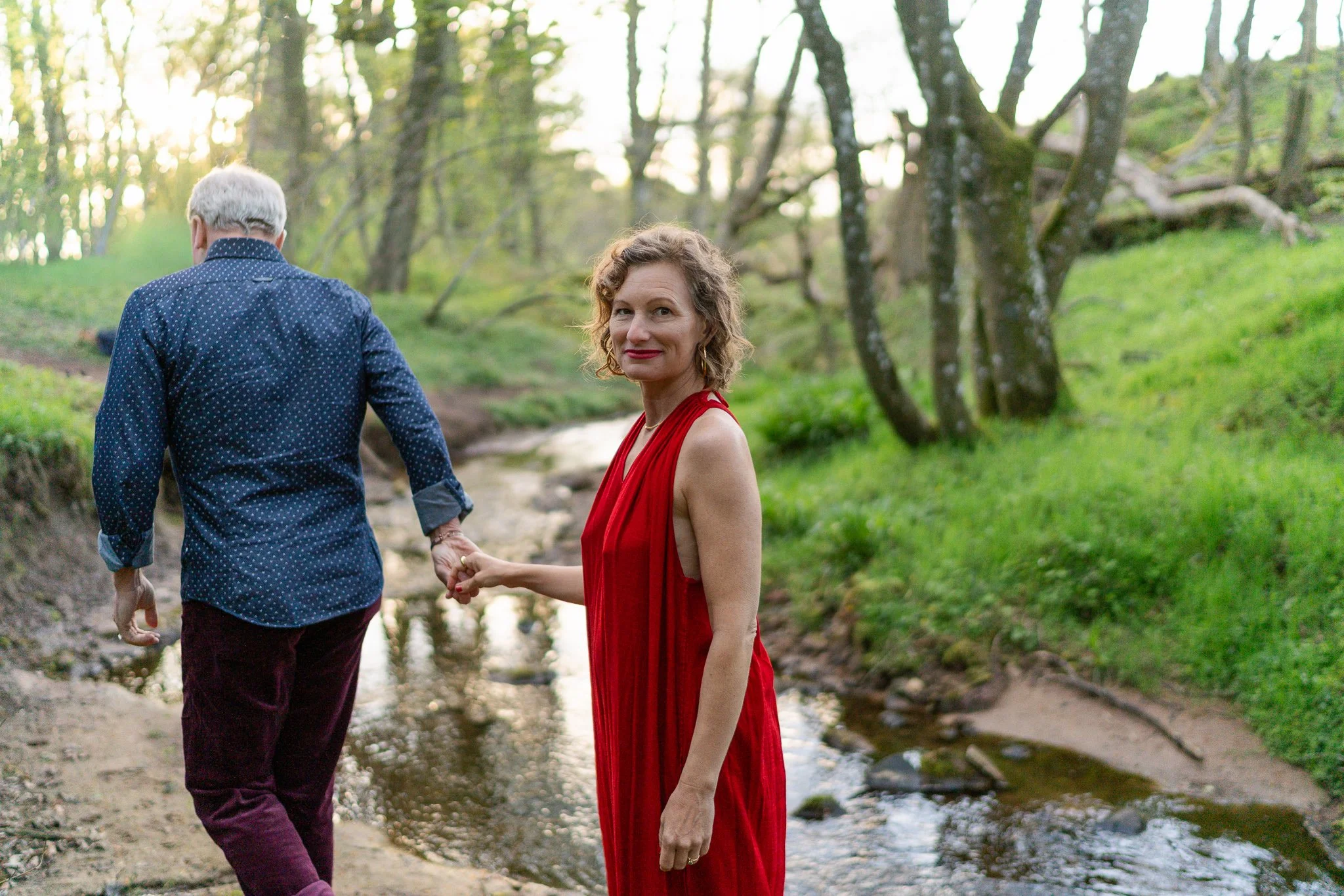 female astrocartographer photographed with her husband by a stream in Scotland