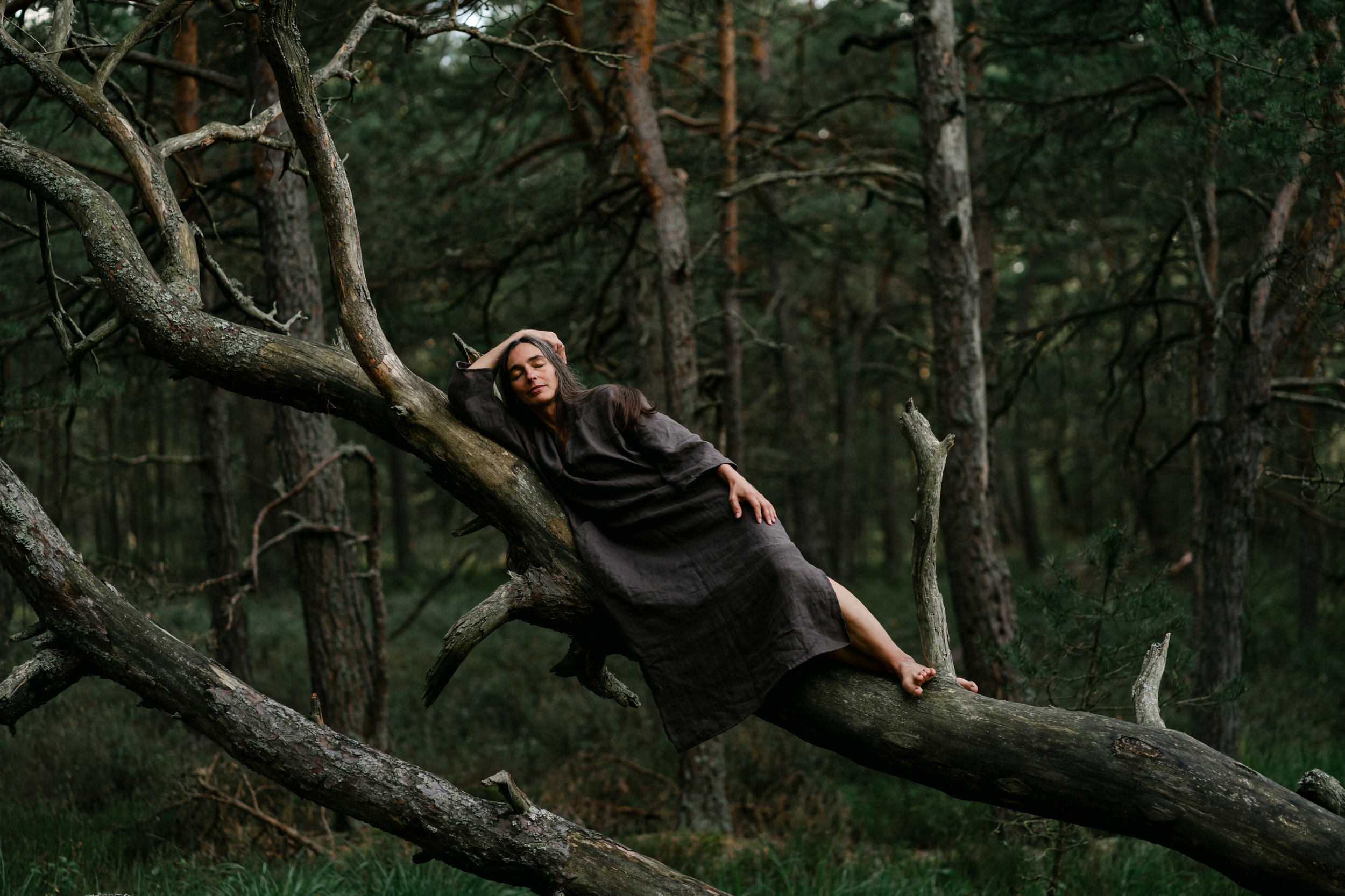 sound healer photographed while resting on a tree in Scotland