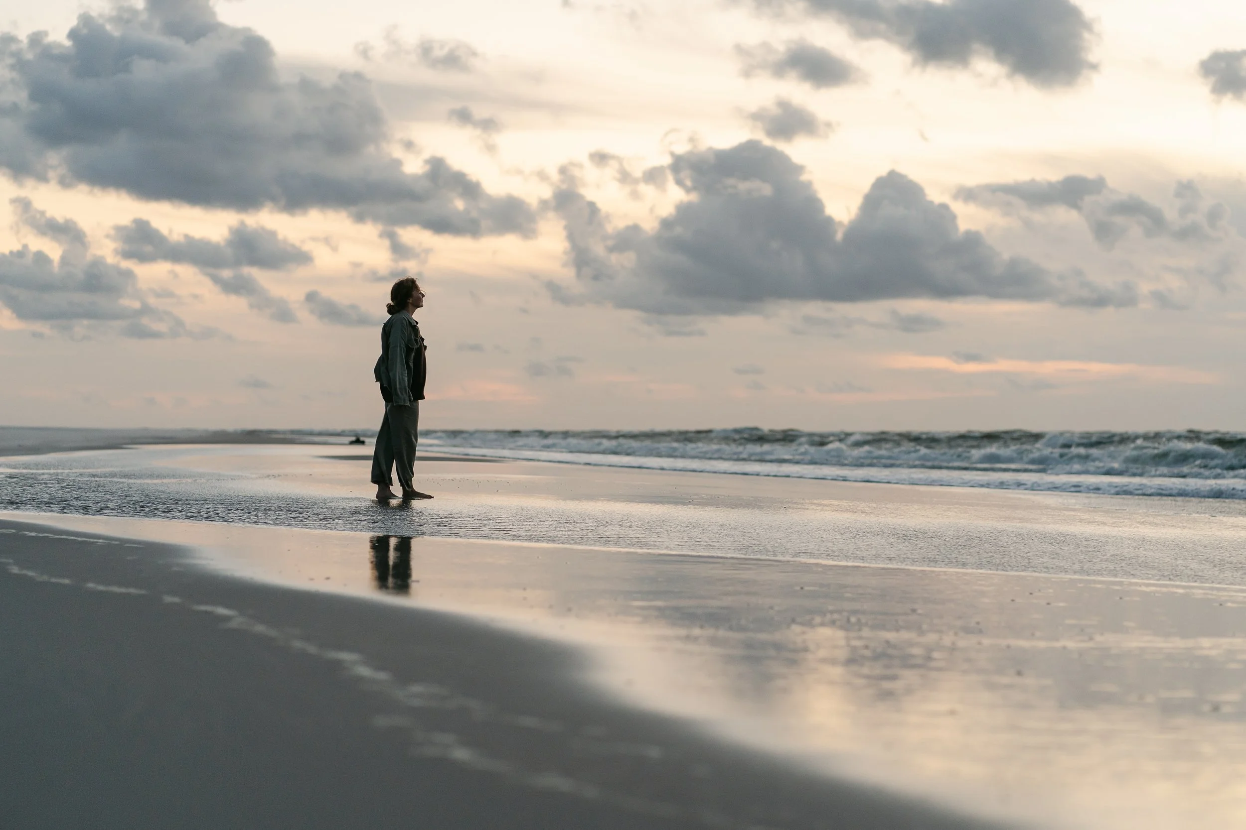 creative business owner photographed on the beach at sunset