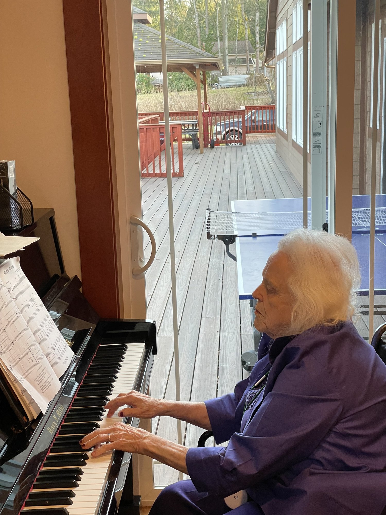 Resident enjoying music at the piano