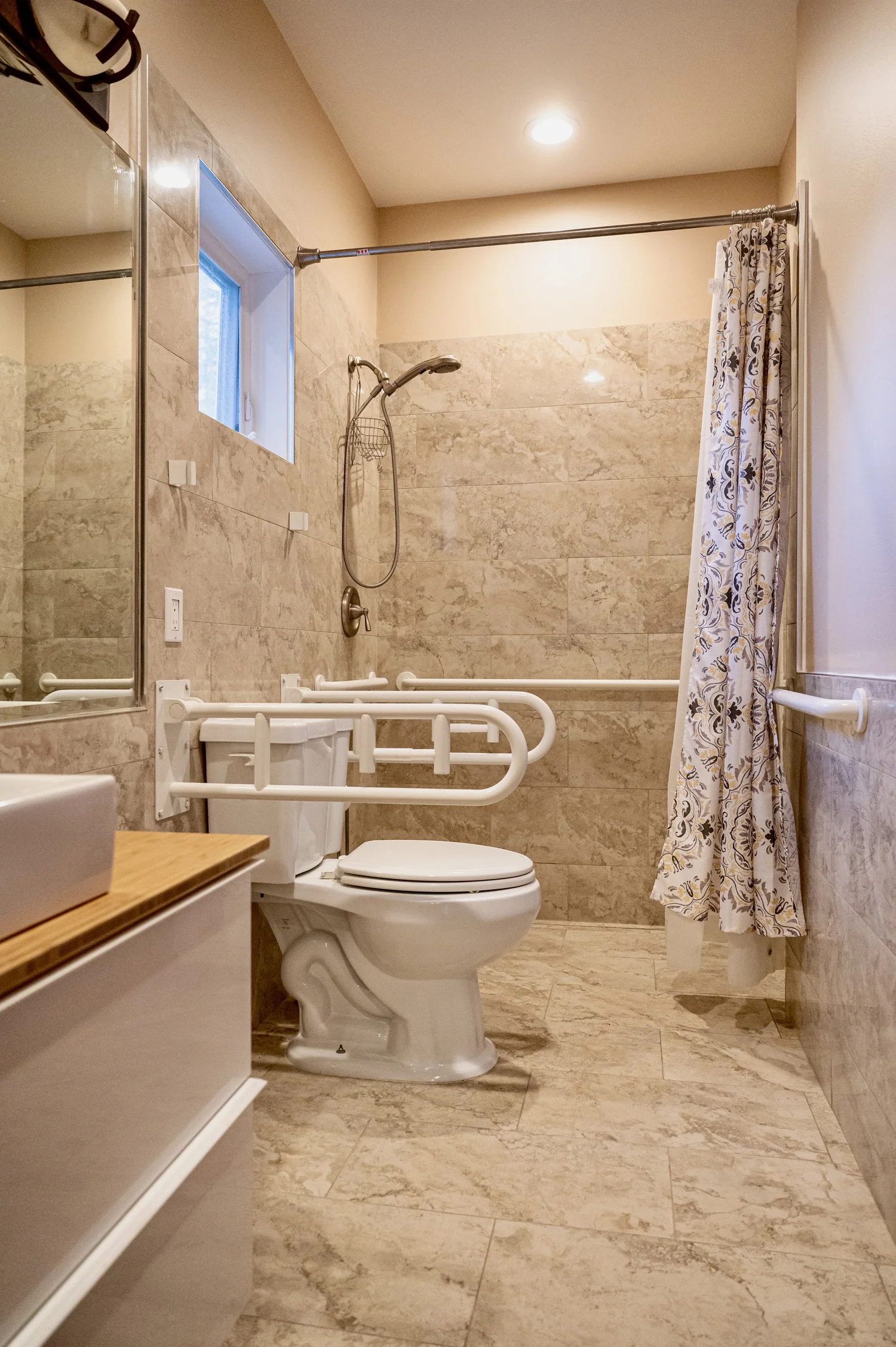 Accessible bathroom with roll-in shower and grab bars