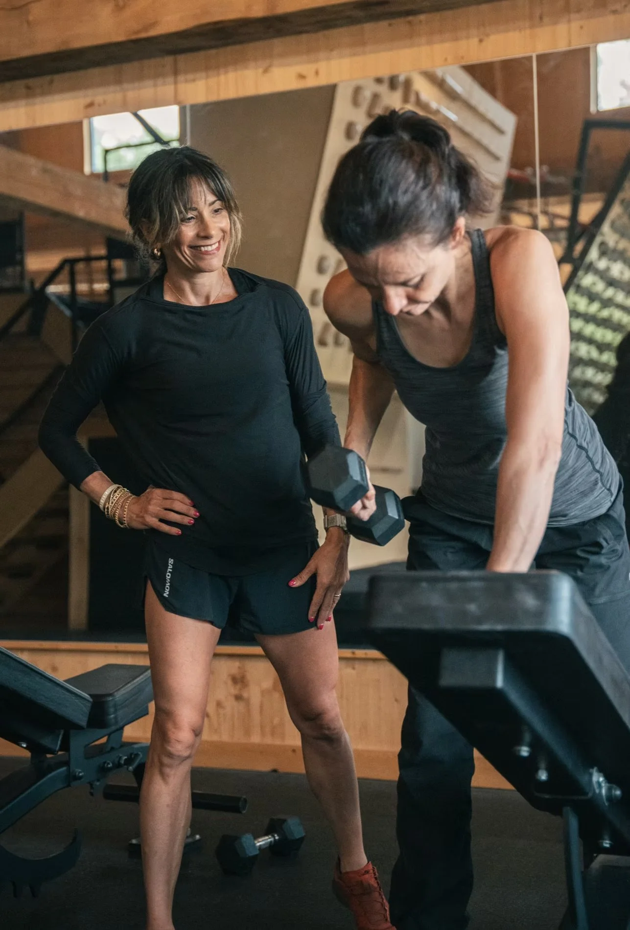 Tina McInnes coaching woman how to lift weights at Klimat Gym in Wakefield, Quebec.