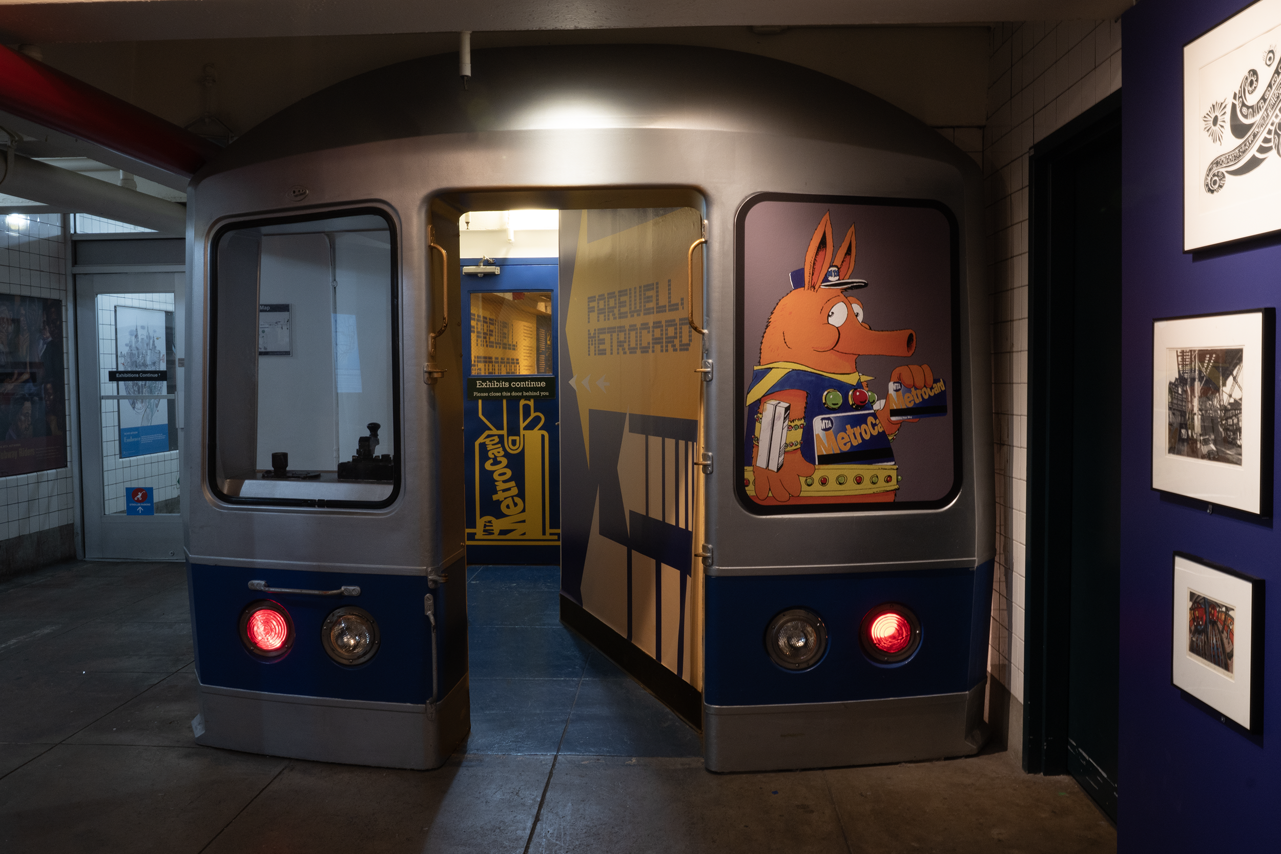 Train facade leading in to the Screening Room, with breadcrumb graphics enticing visitors to enter FAREwell, MetroCard