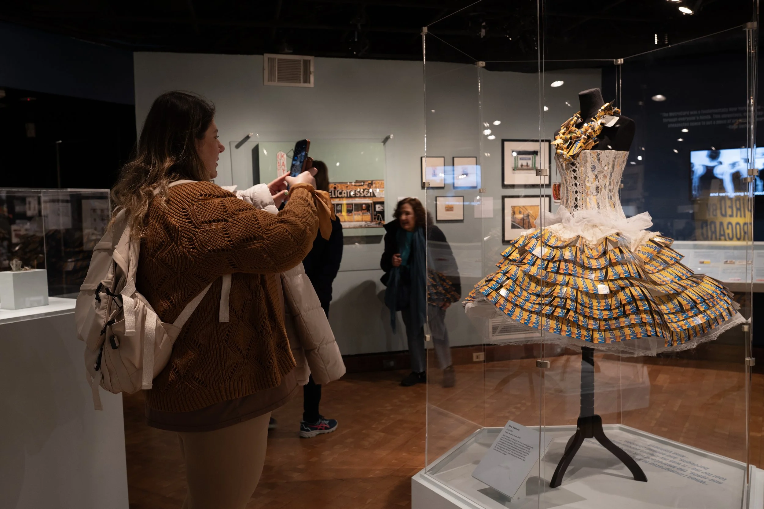Museum visitor takes a photo Nina Vishneva's MetroCard wedding dress
