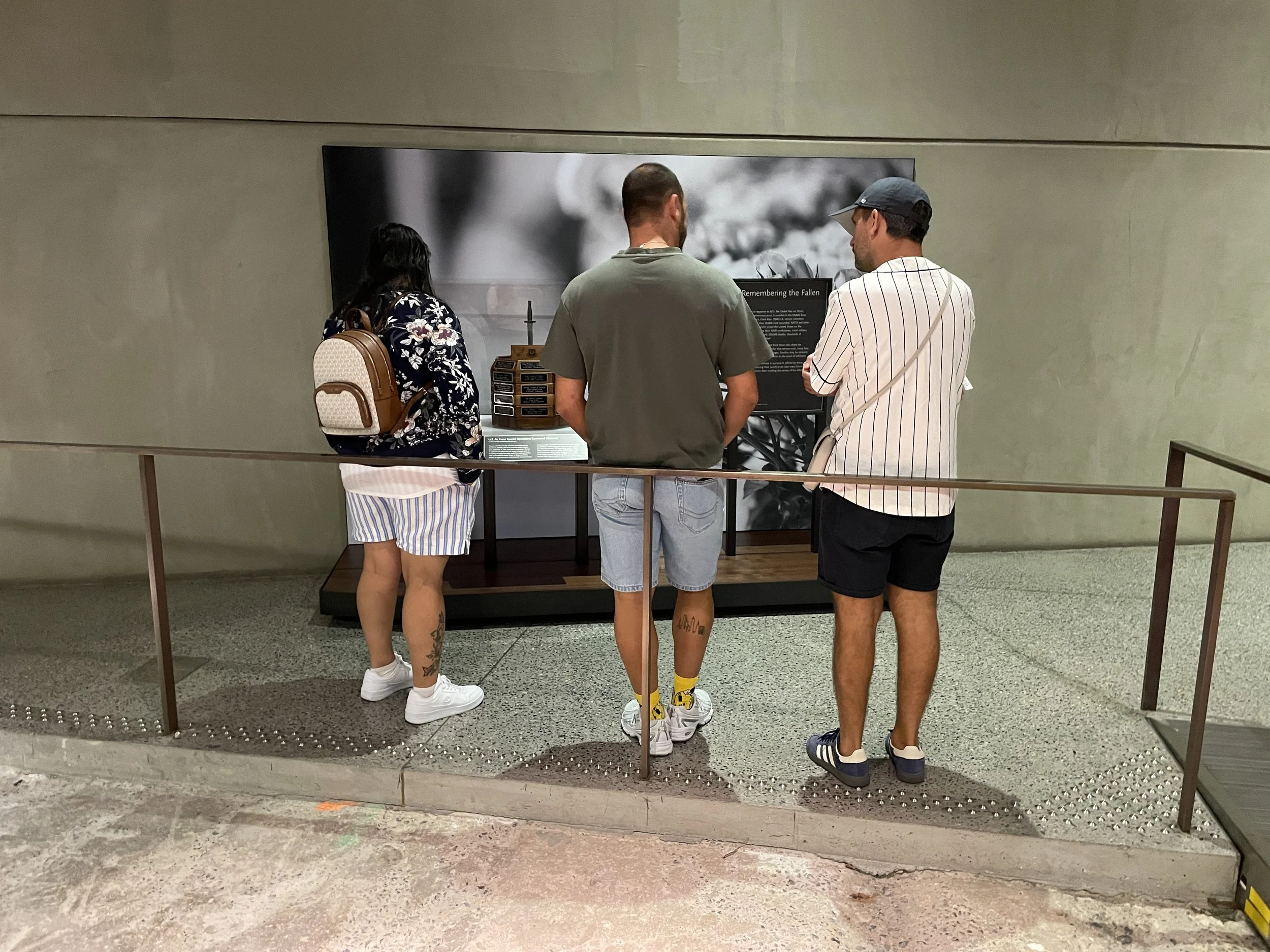 Visitors engaging with the East Triangle installation at the 9/11 museum