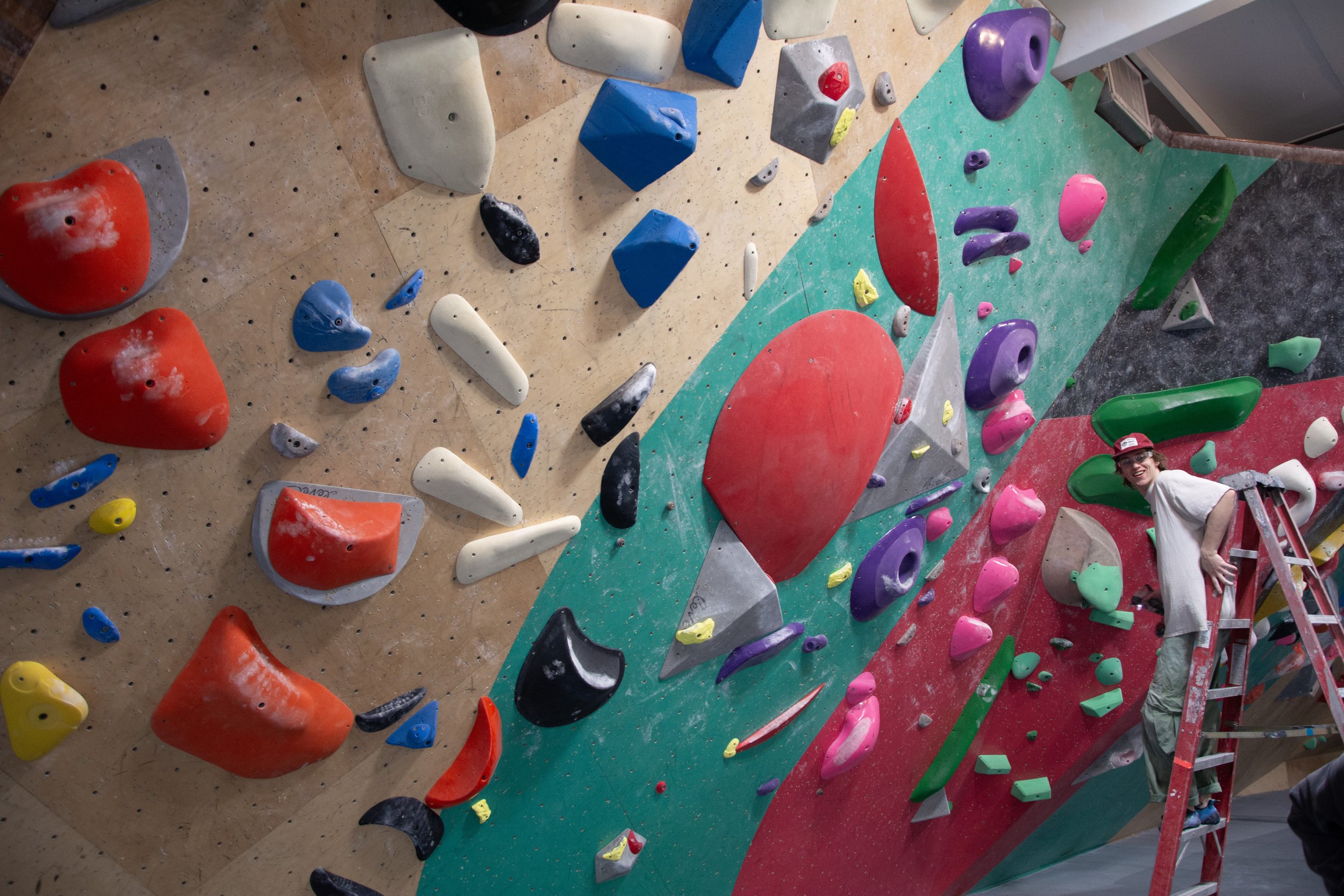 Routesetter Kailas Sullivan while putting up new bouldering routes at Uplift Climbing in Shoreline, Wash.