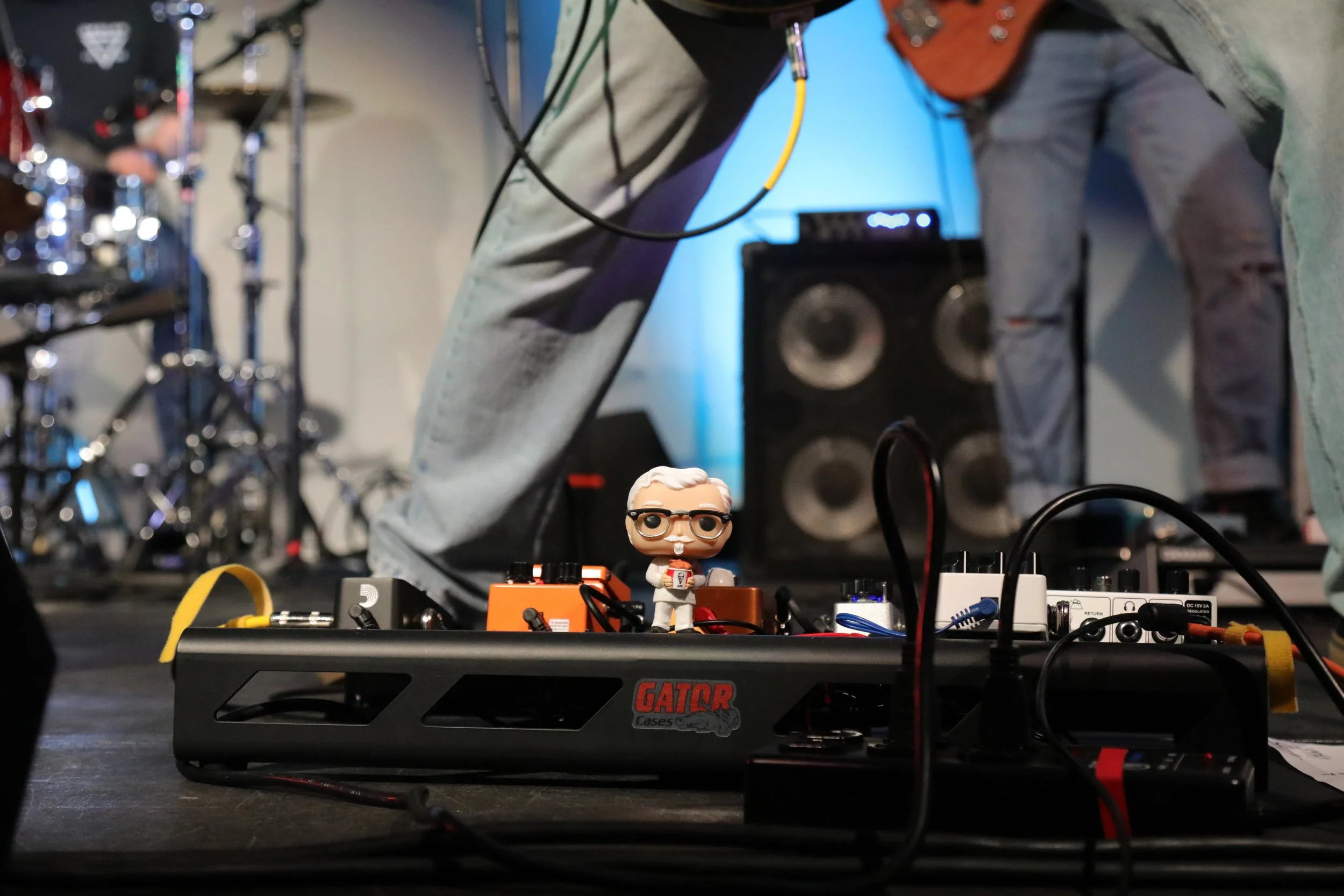 A figurine of KFC's mascot Colonel Sanders stands amongst guitarist's equipment during a live performance at Western Washington University in Bellingham, Wash.