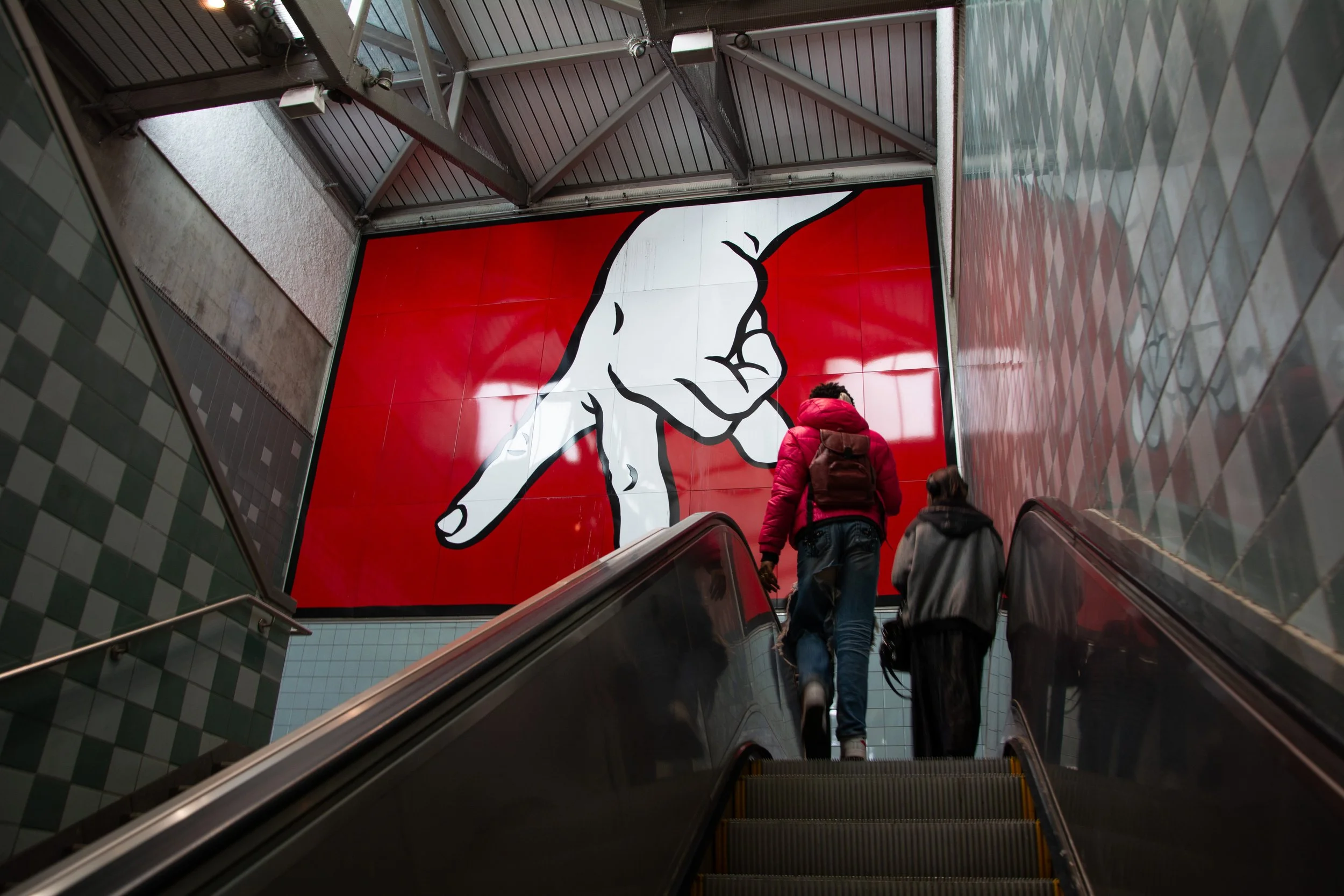 A group of pedestrians exit the Capitol Hill Link Light Rail station in Seattle, Wash.