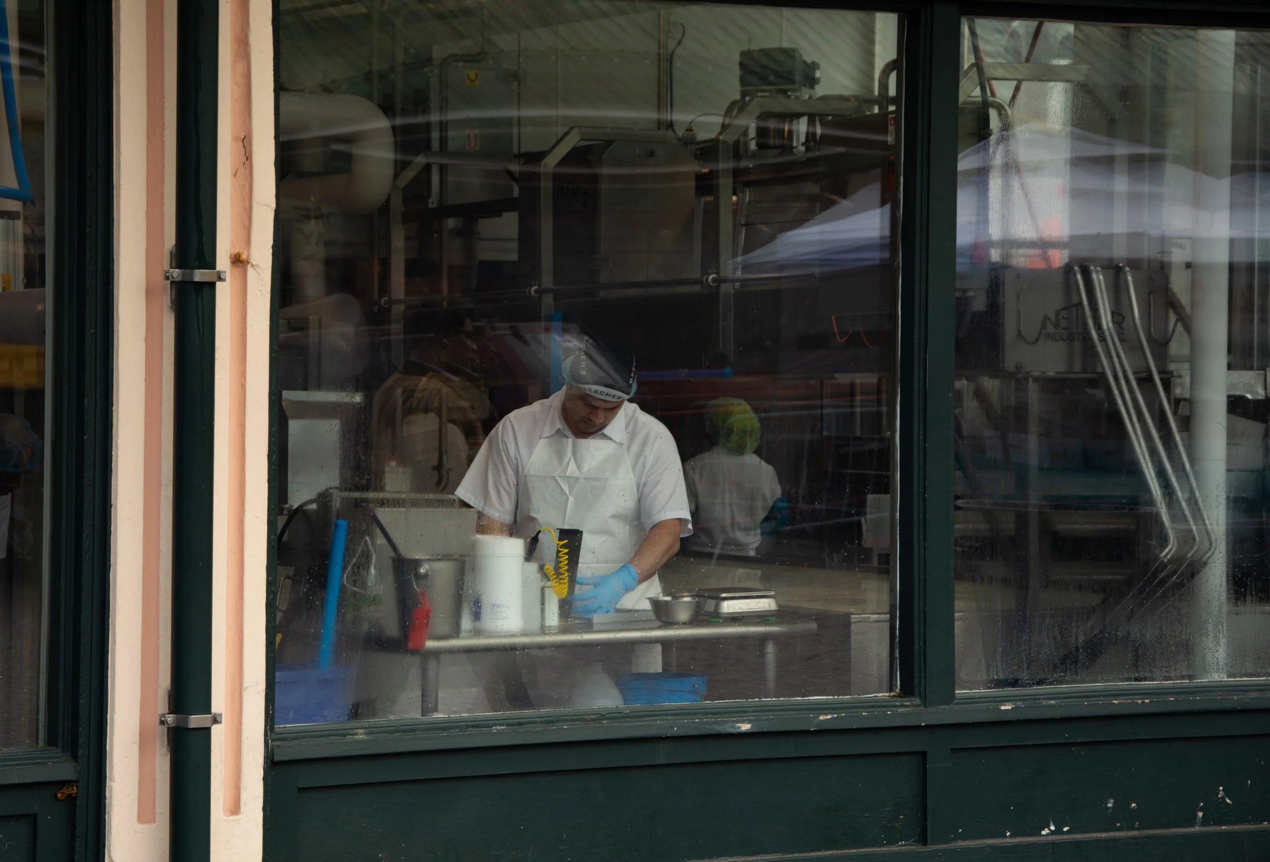 A person working inside of Beecher's Handmade Cheese across the street from Pike Place Market in Seattle, Wash.