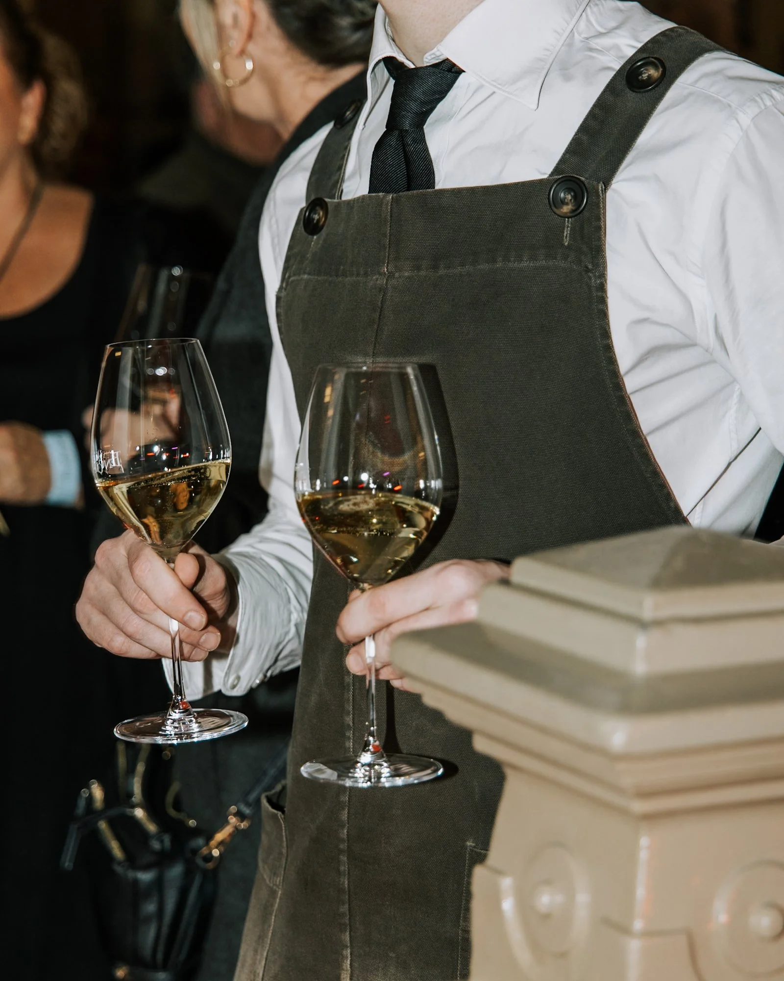 Waiter serving wine to guests during a private cocktail function at Pendolino.
