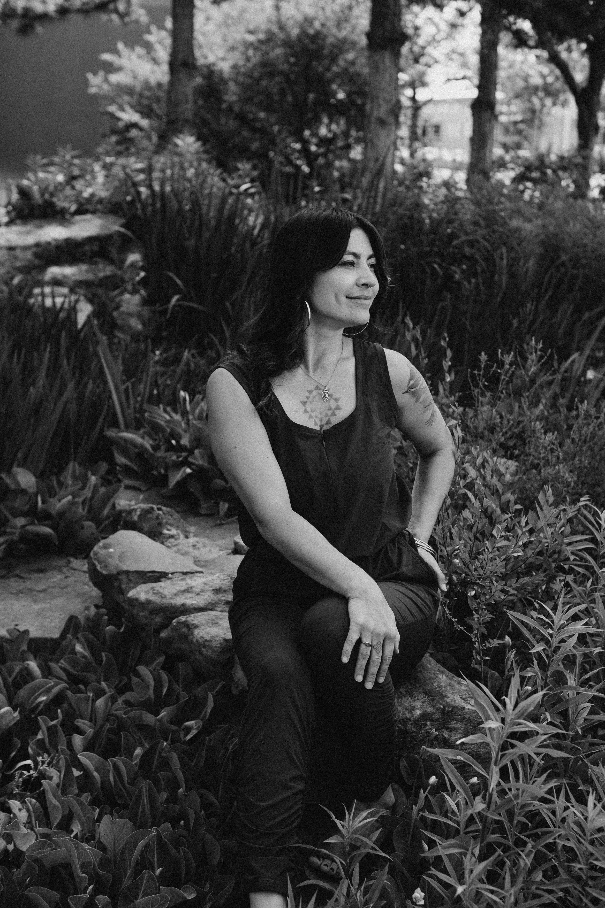 Sex Coach Zhenya Novareign posing for bio shot among yerba mansa plants in Albuquerque, New Mexico.