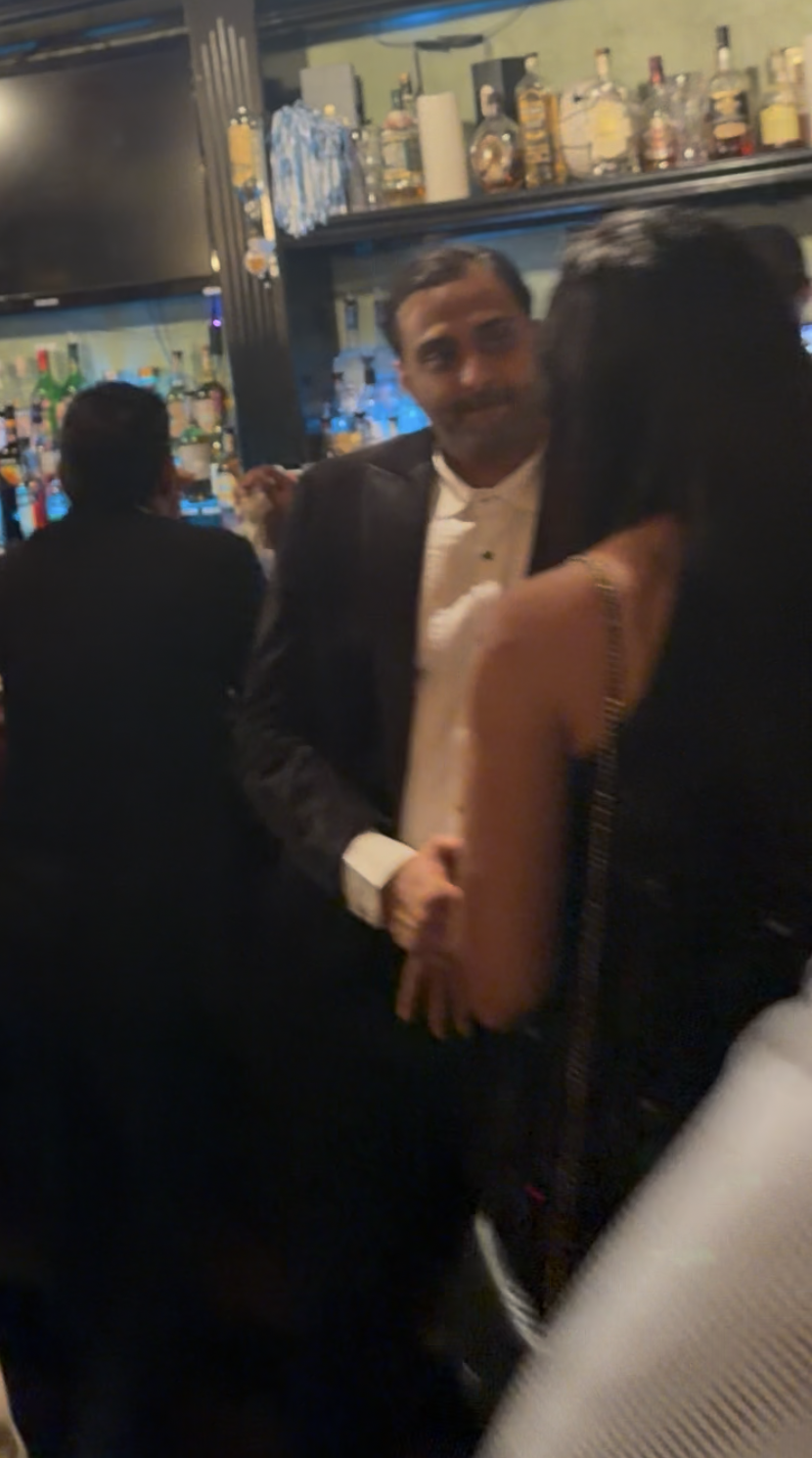 Two South Asian singles having a focused conversation during a weekend social event