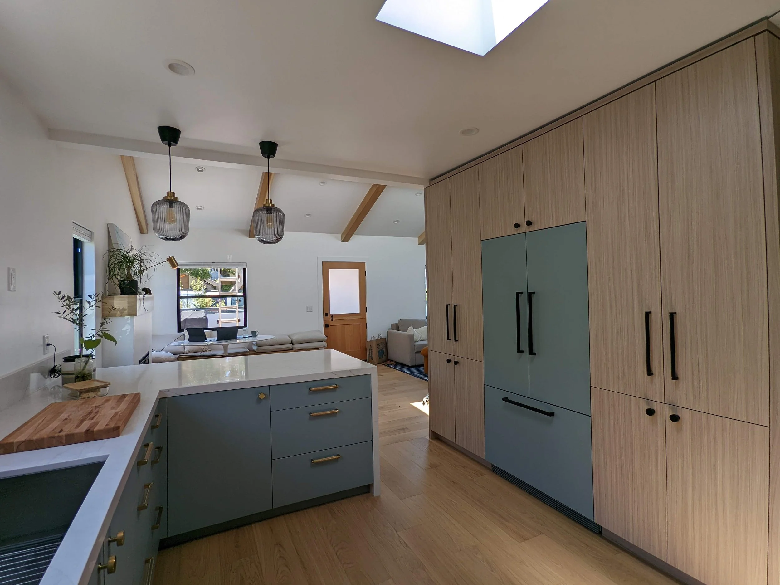 Integrated refrigerator with pantry to the left and coffee bar to the right. 