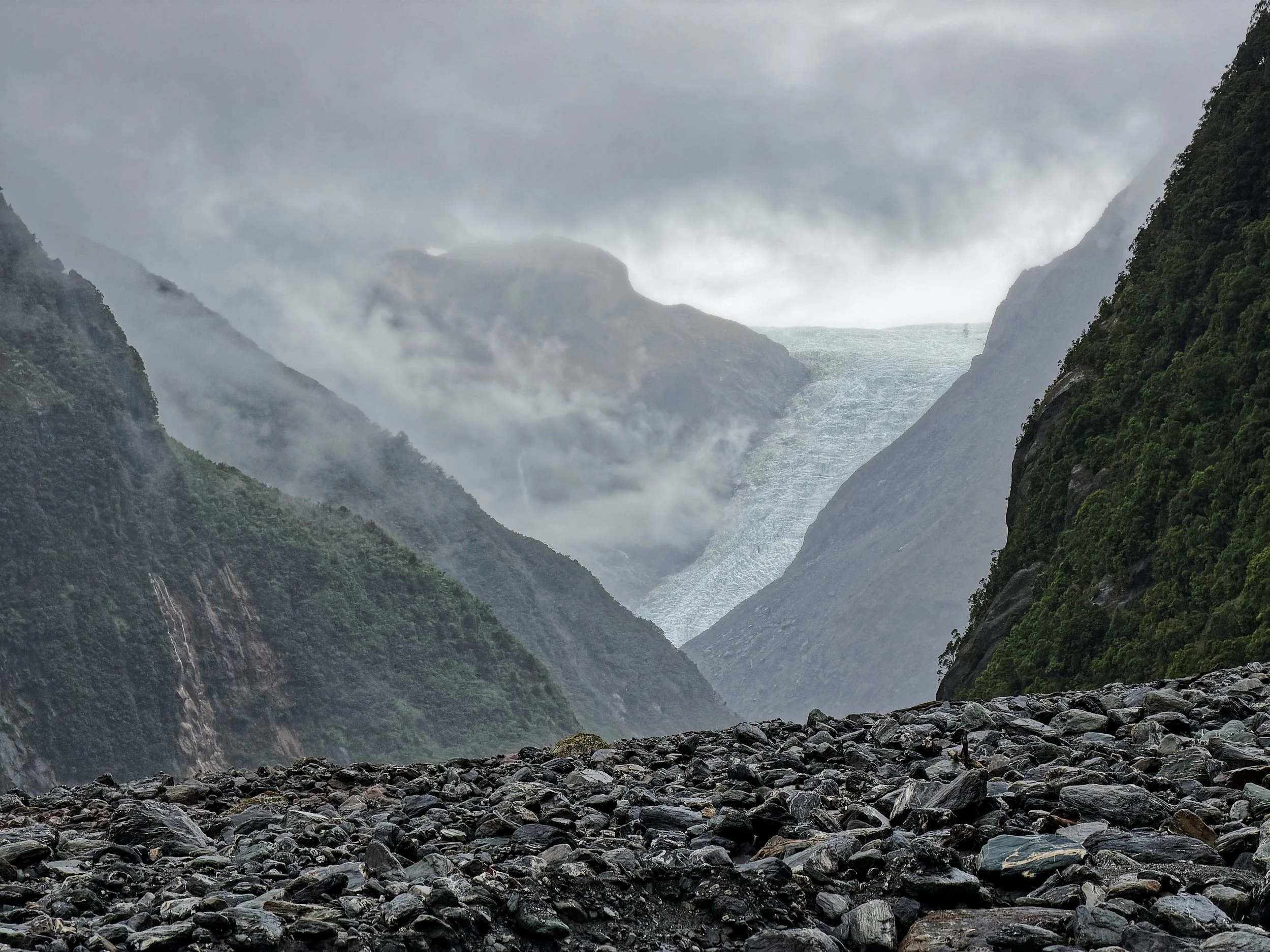 Fox Glacier and freshly eroded boulders brought down by frequent debris flows, western Southern Alps