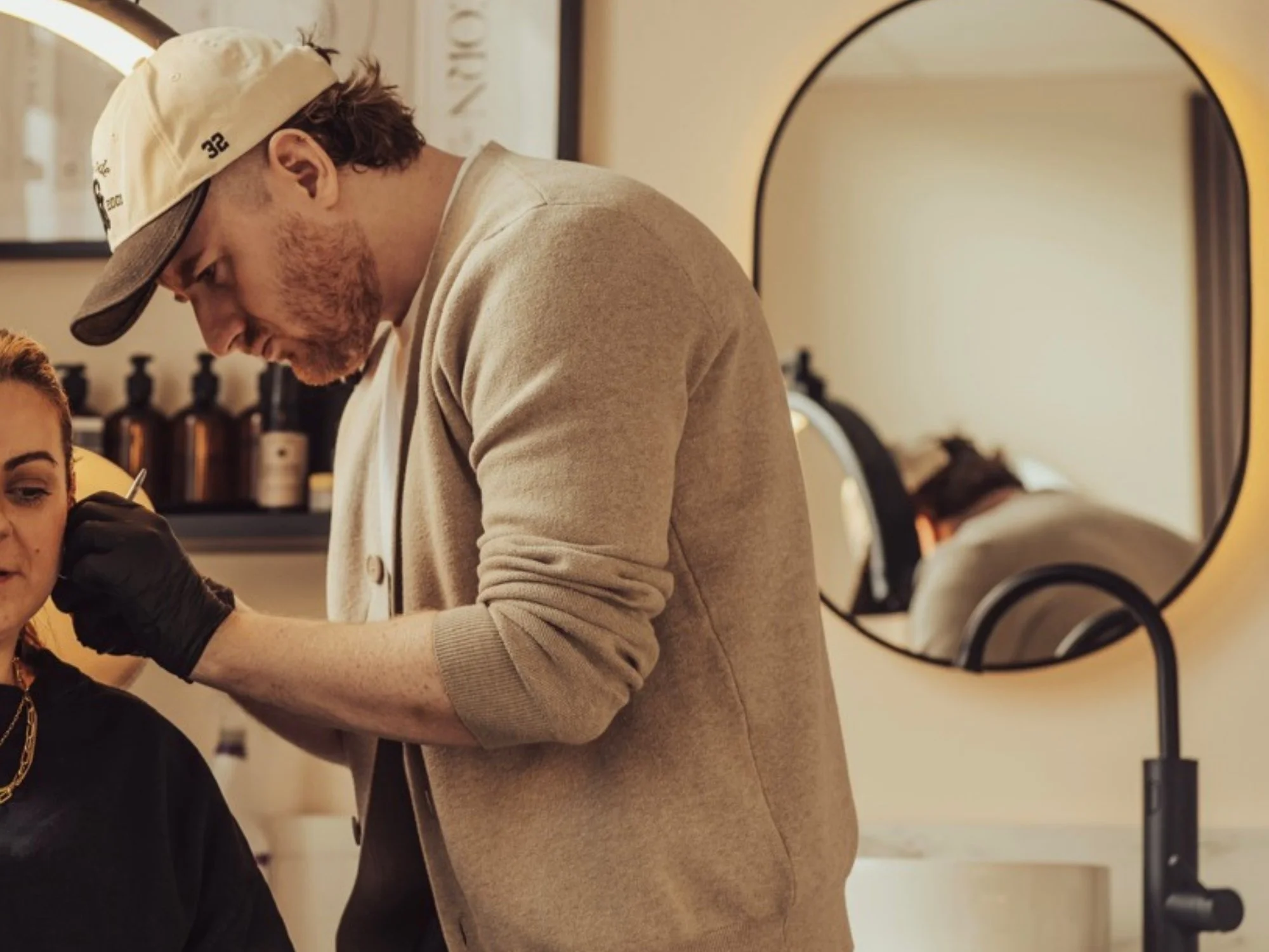 Needle-only ear piercing process during a luxury piercing appointment at BLINK Renfrew