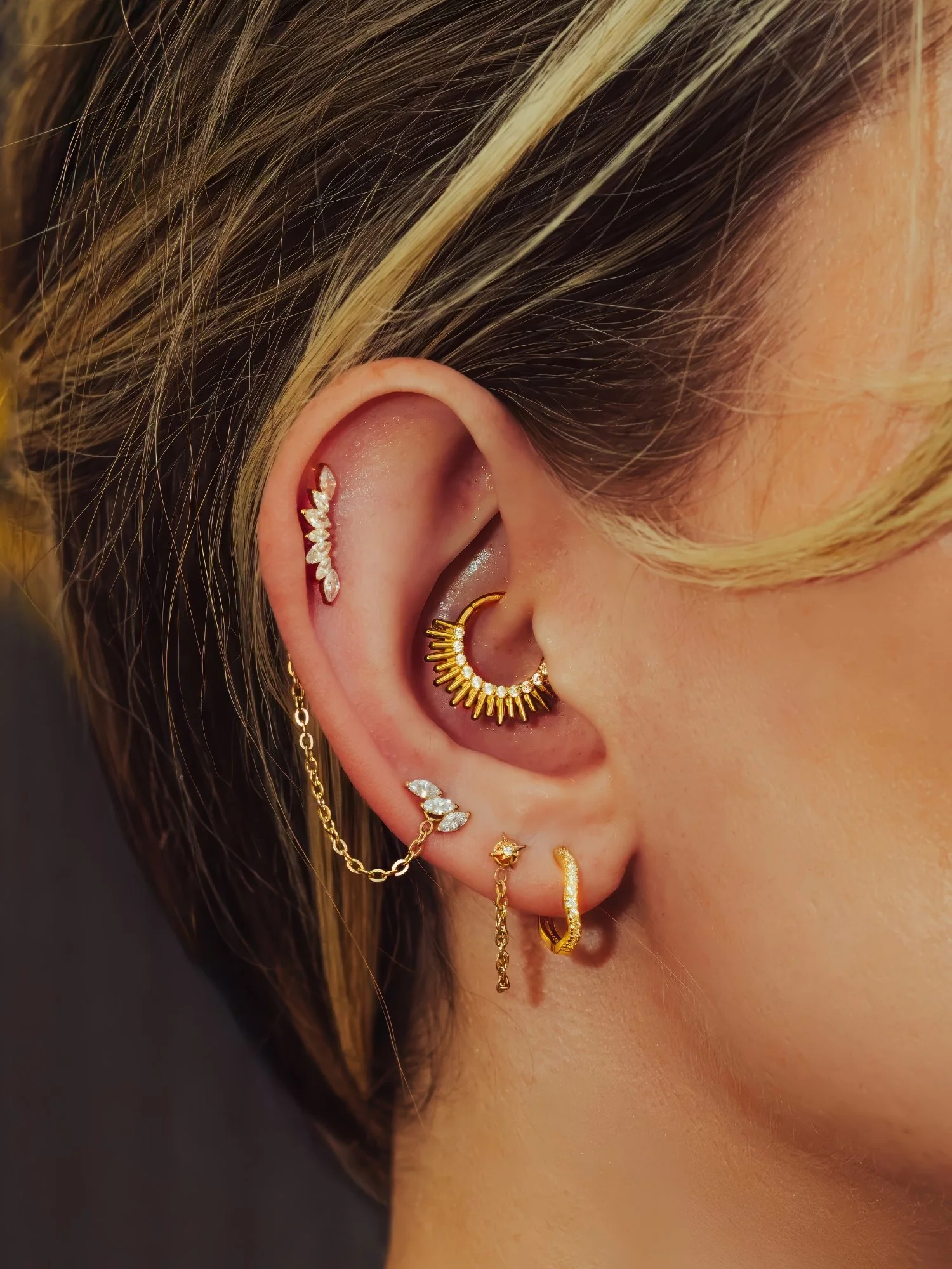 Needle-only luxury ear piercing and curated ear styling at BLINK Beauty in Renfrew
