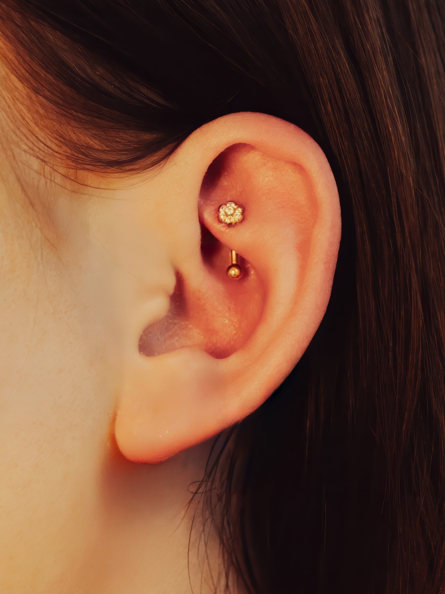 Rook piercing with a curved barbell jewellery and lotus stone.