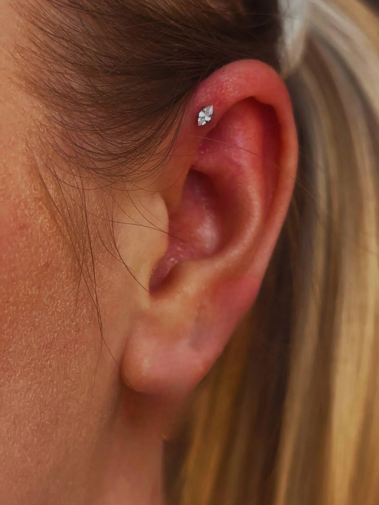 Forward Helix Piercing with a drop stone piercing.