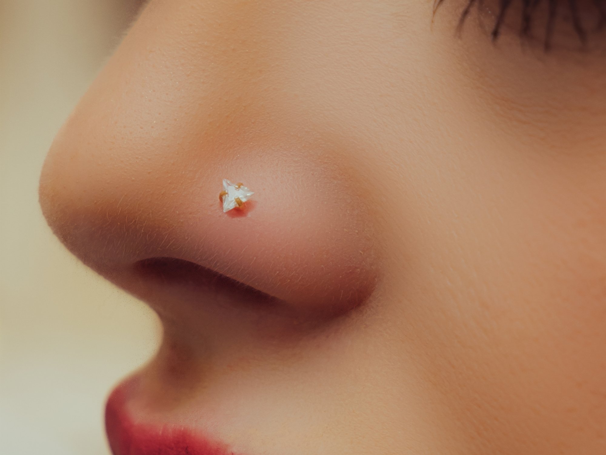Nostril piercing with implant grade titanium jewellery at BLINK Beauty in Renfrew
