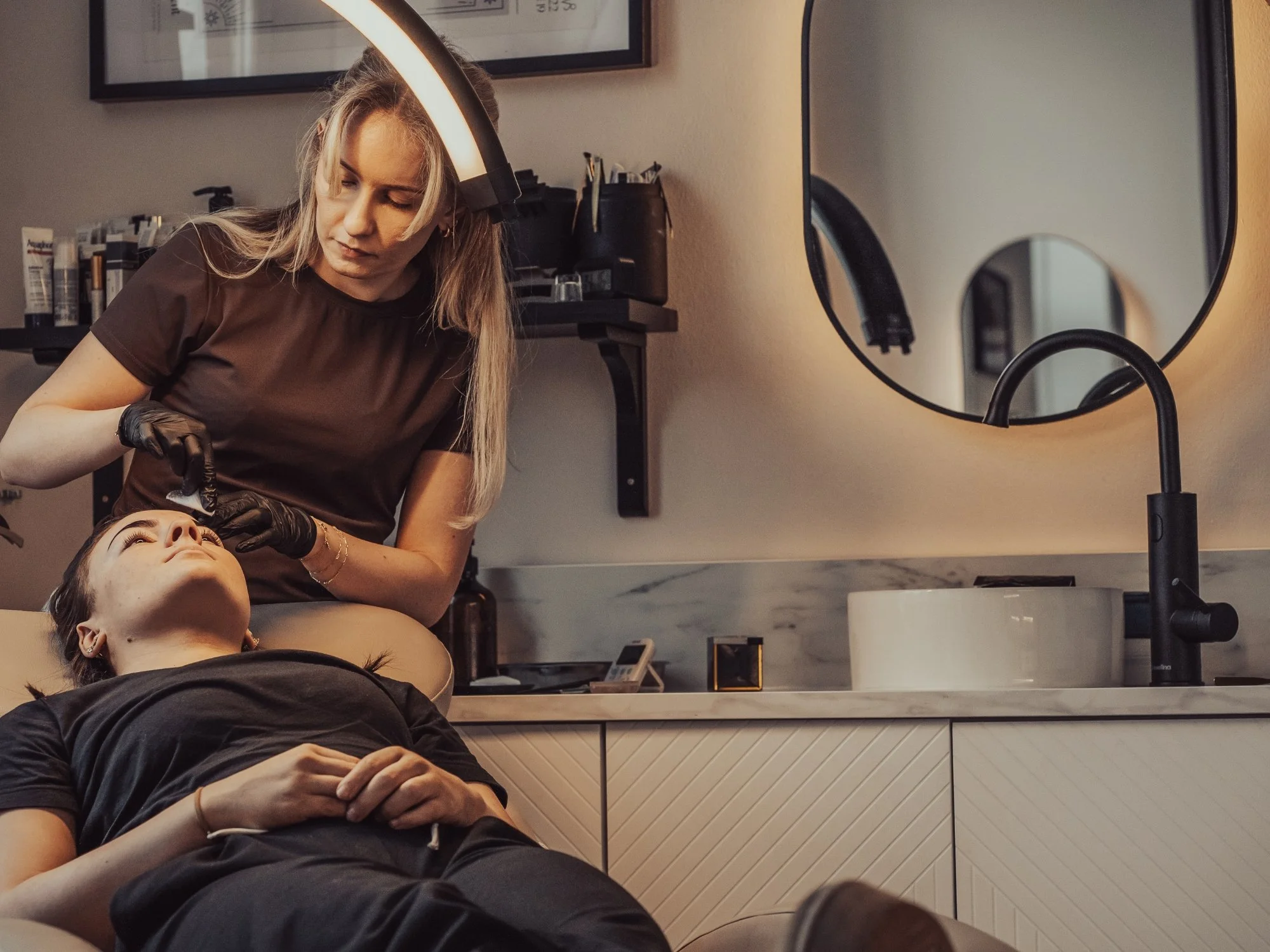 Professional brow treatment being carried out at BLINK Beauty studio in Renfrew