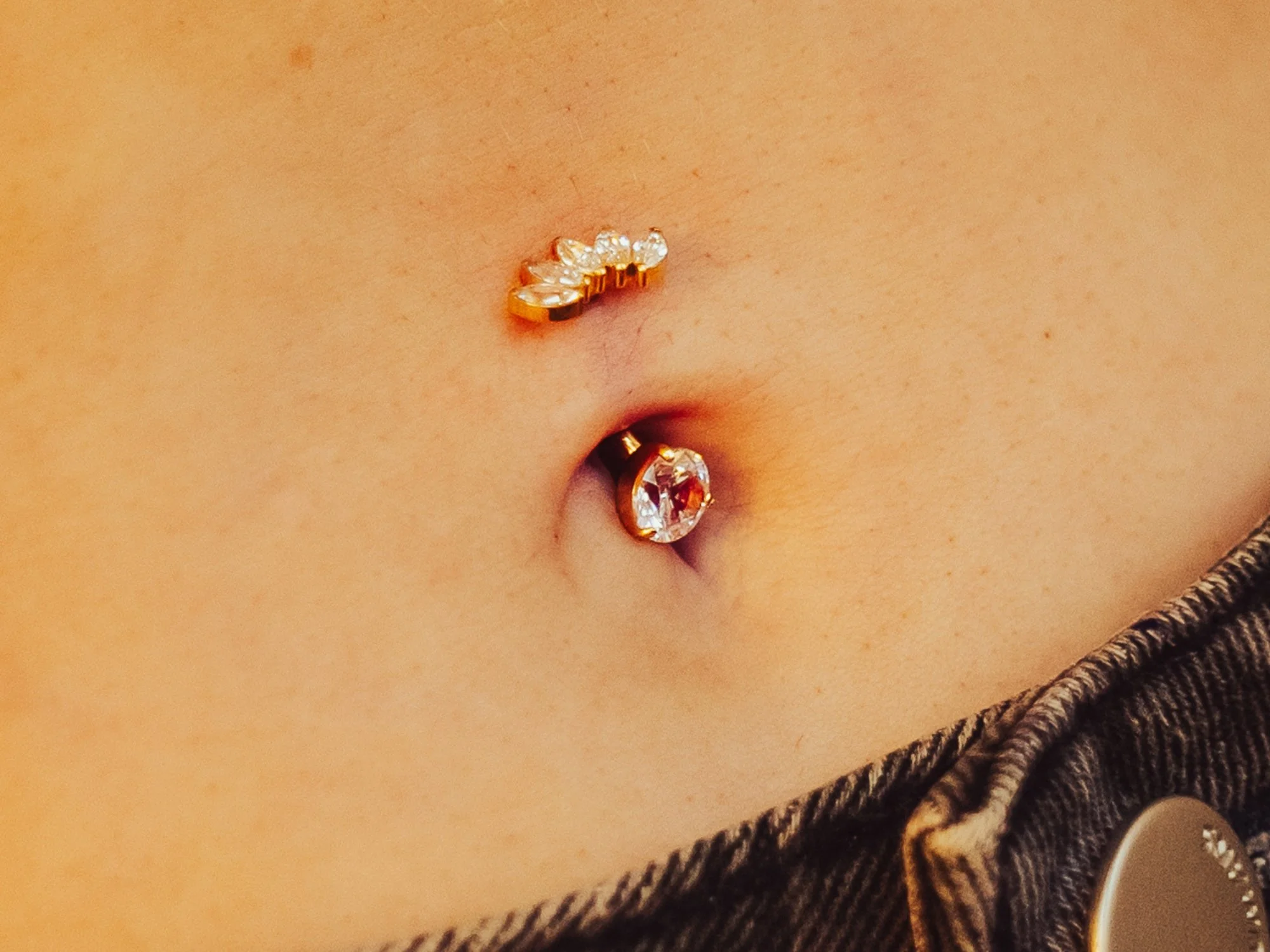 Navel piercing with implant grade titanium jewellery at BLINK Beauty in Renfrew