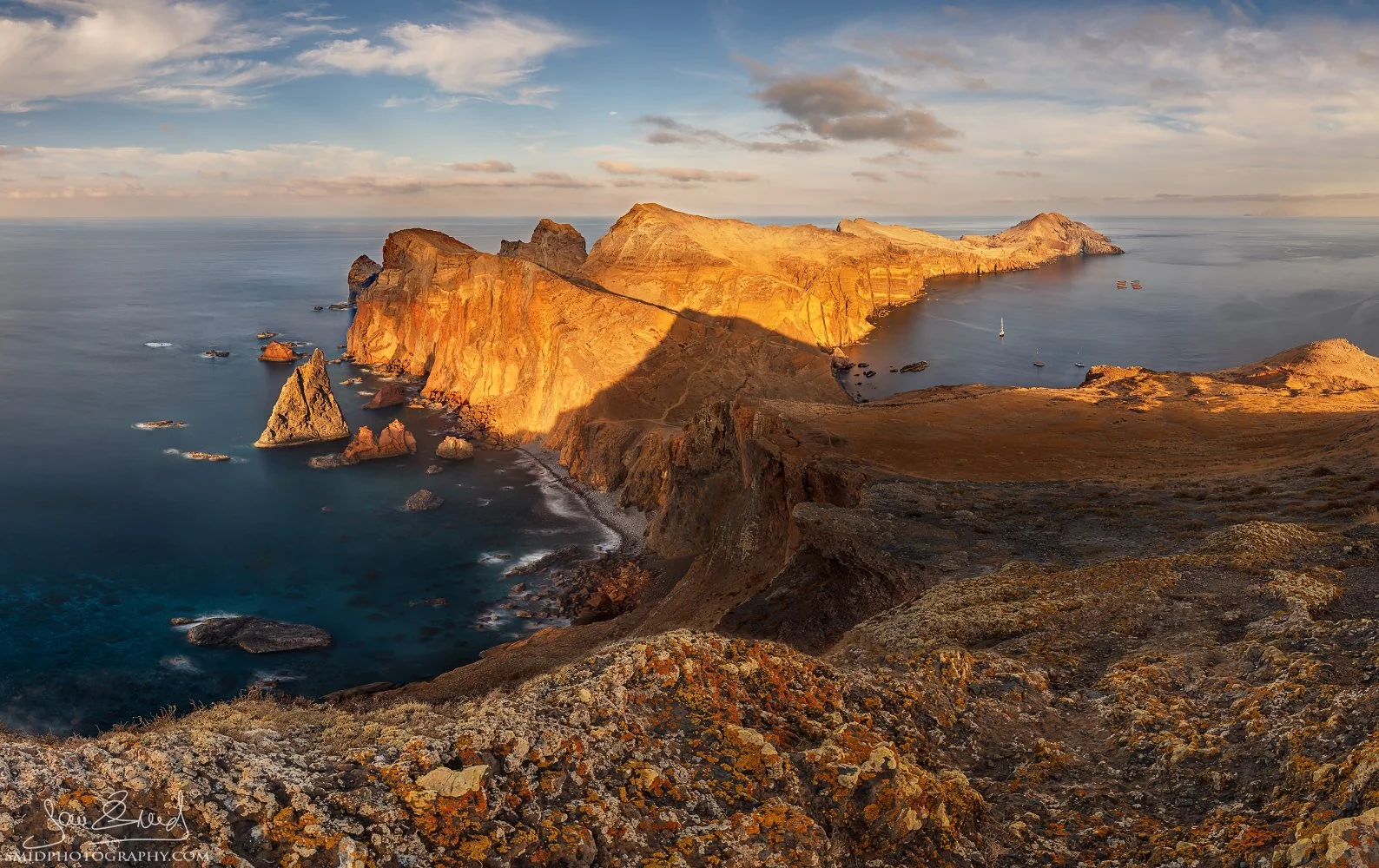 Dramatic panoramic landscape photograph "Dragon's Teeth" at Ponta de São Lourenço, Madeira. Featuring the sharp eastern cliffs illuminated by rare sunset light. Captured by Jan Smid, Master QEP, in 2018.