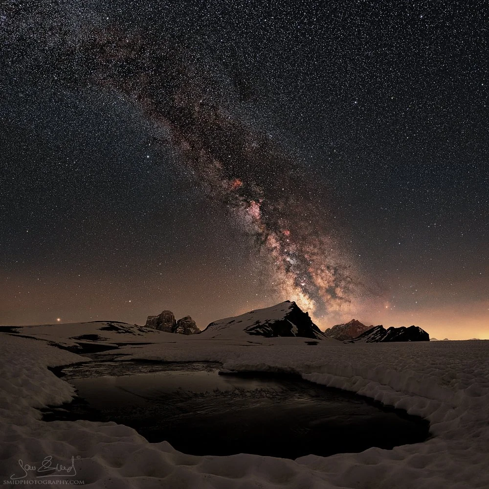 The summer Milky Way above snowy Dolomite peaks and winter-like landscape by Jan Smid, Master QEP.