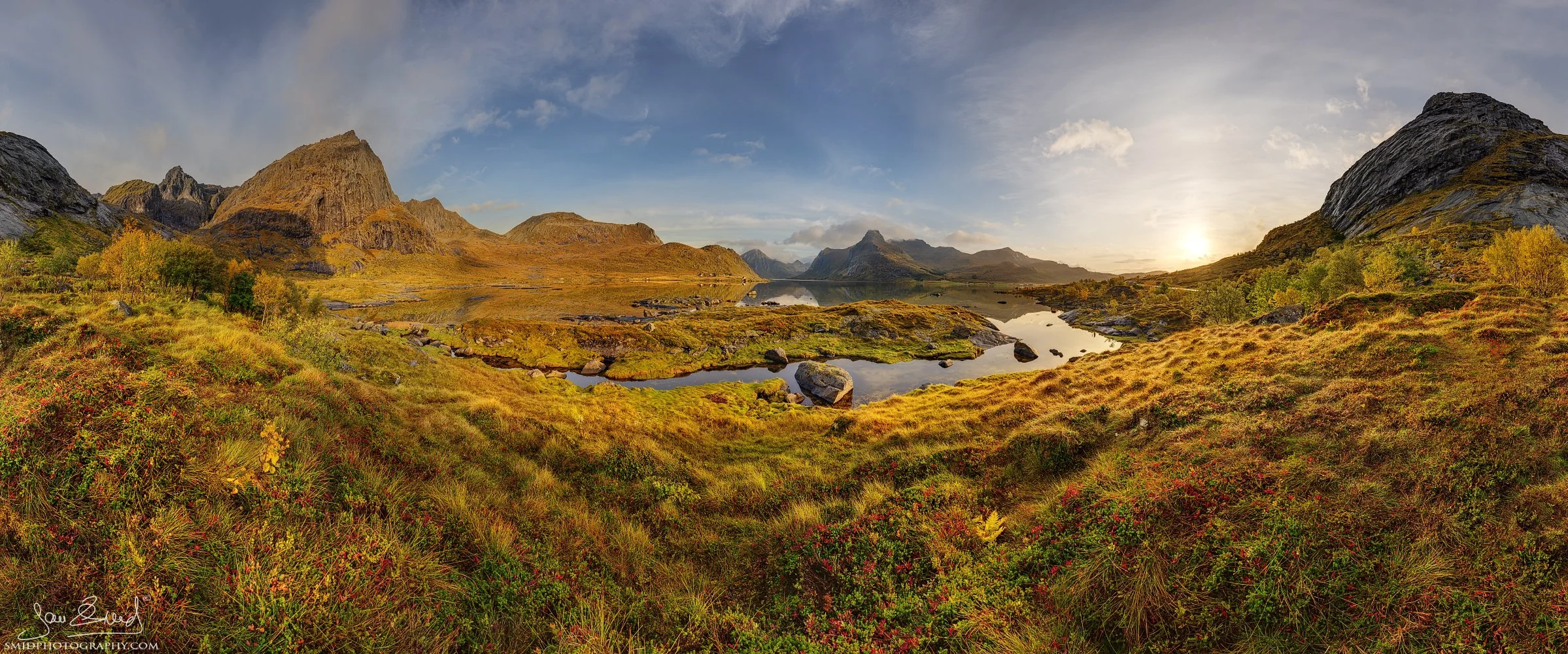 Panoramic landscape photograph "Finally Here" capturing the crisp morning light shortly after sunrise over the snow-covered peaks of the Lofoten Islands. Captured by Jan Smid, Master QEP, in 2023.