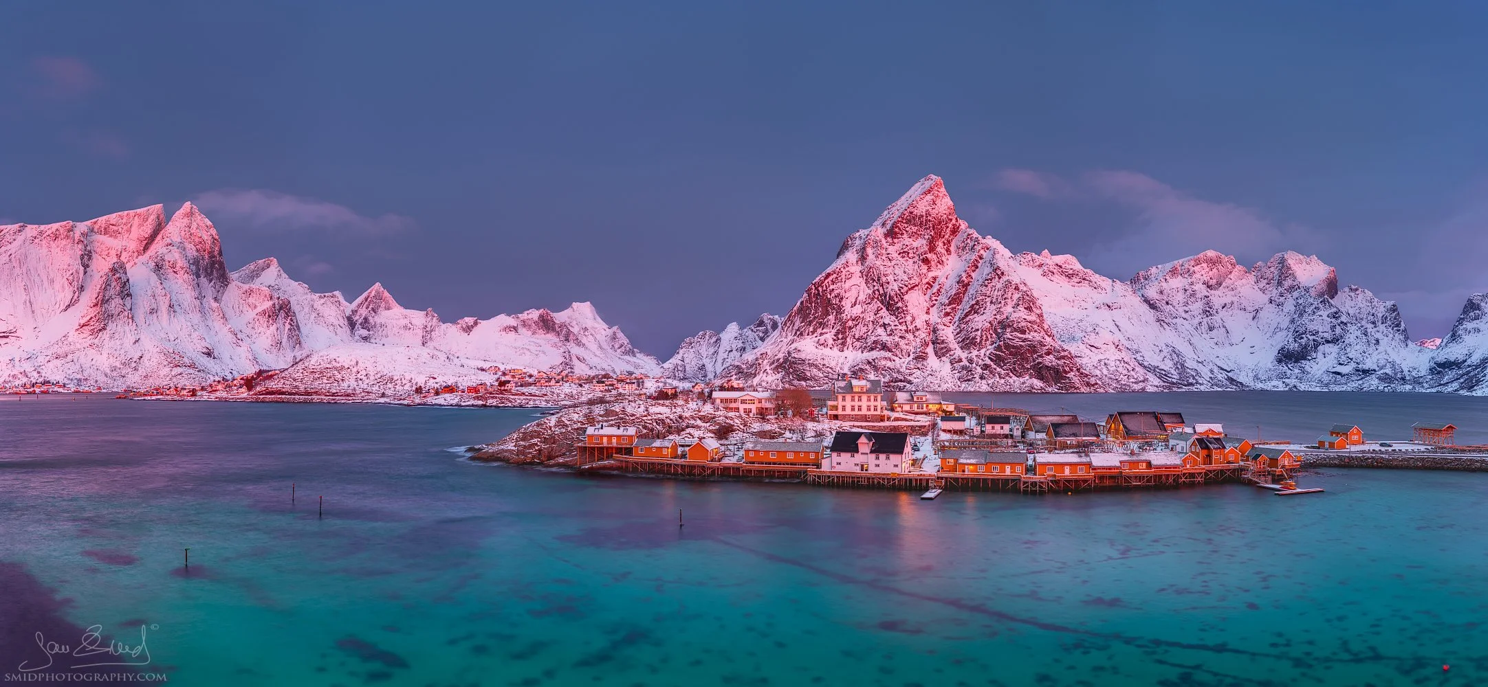 Panoramic landscape photograph "Winter Island" featuring a snow-covered island in the middle of frozen arctic waters. Captured by Jan Smid, Master QEP, in 2020.