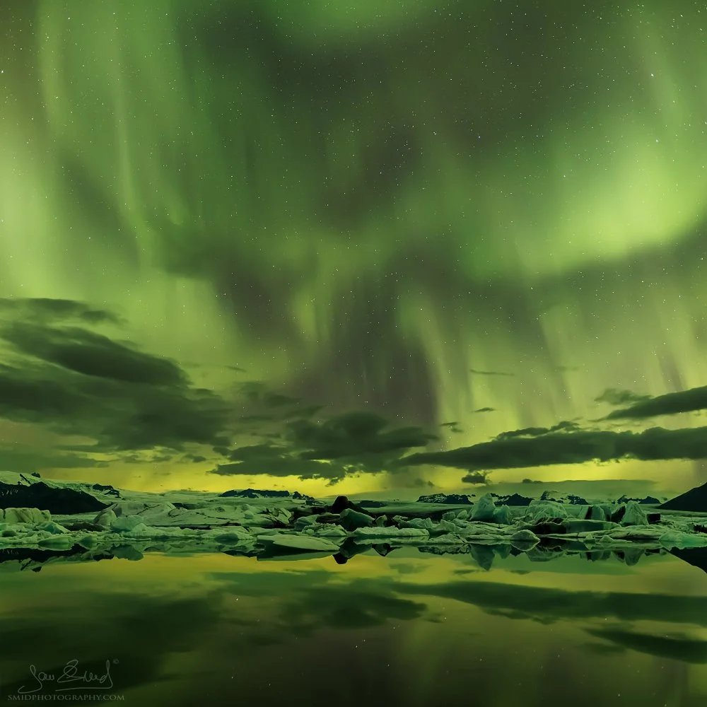 Breathtaking night panorama titled "Green Spirits" featuring vibrant Northern Lights (Aurora Borealis) over Jökulsárlón glacier lagoon, Iceland. Captured by Jan Smid, Master QEP, during a 2015 photo expedition. High-end fine art.
