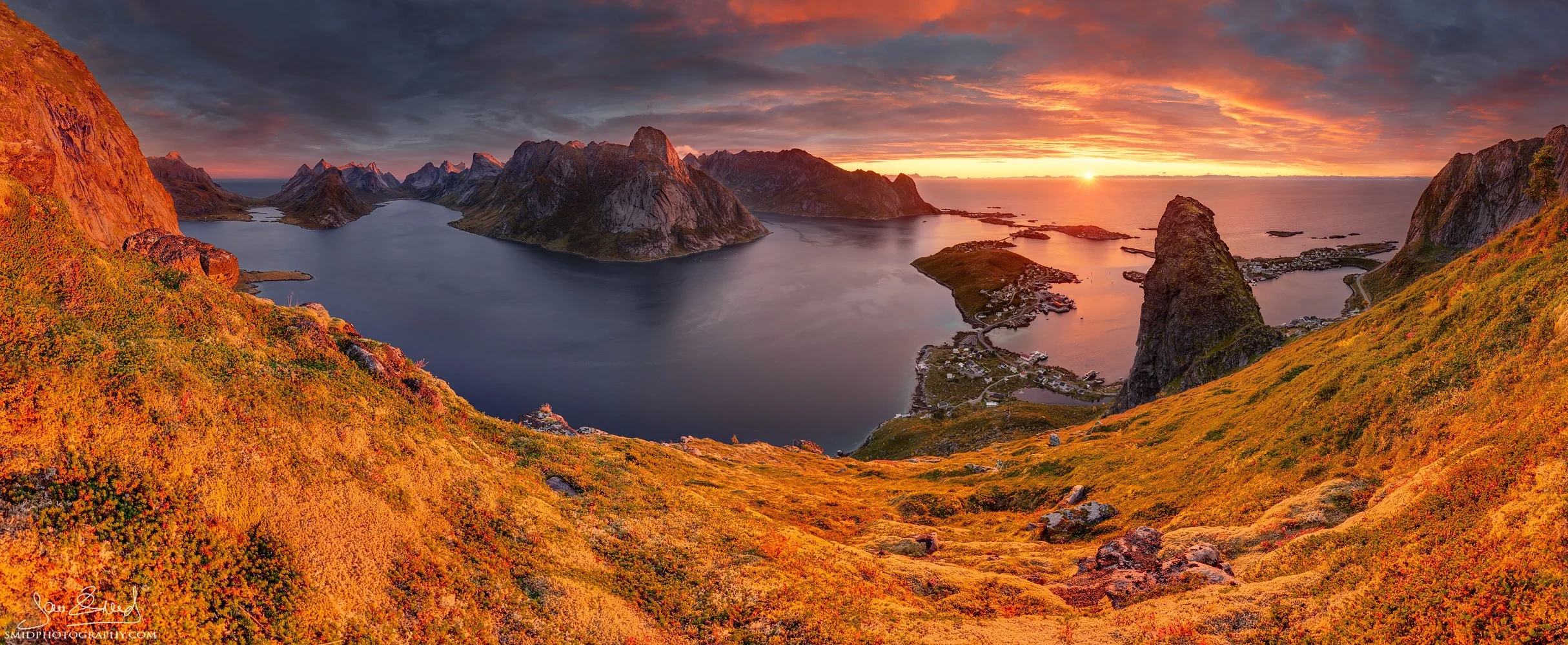 Multi-award-winning panoramic photograph "Burning Mountain Ridges" showing a fiery autumn sunset over a remote fjord in Lofoten. Captured at a secret location by Jan Smid, Master QEP, in 2017.