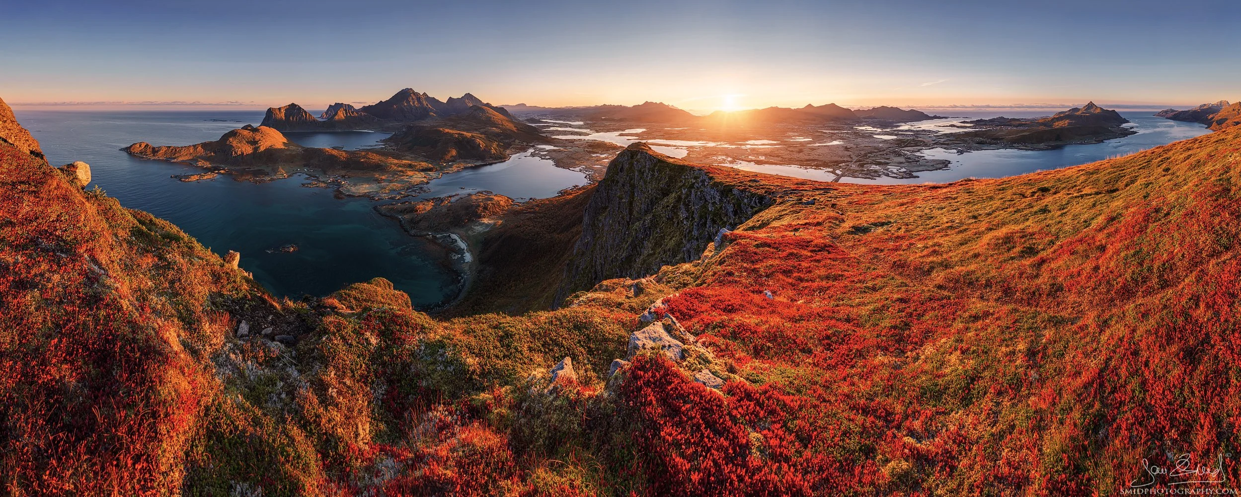 Autumn sunrise panorama captured by Jan Smid, Master QEP, during his professional Lofoten photo expedition. Red blueberry carpets, golden grasses, and a stunning view toward Skottinden, Mannen, Leknes, and Veggen.