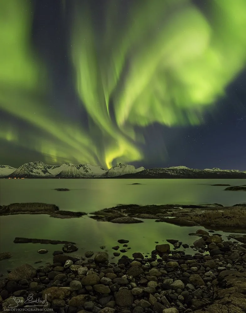 Aurora Borealis reflecting on Pebbly Beach, Lofoten Islands. Panoramic expedition photography by Jan Smid, Master QEP, captured in 2016.