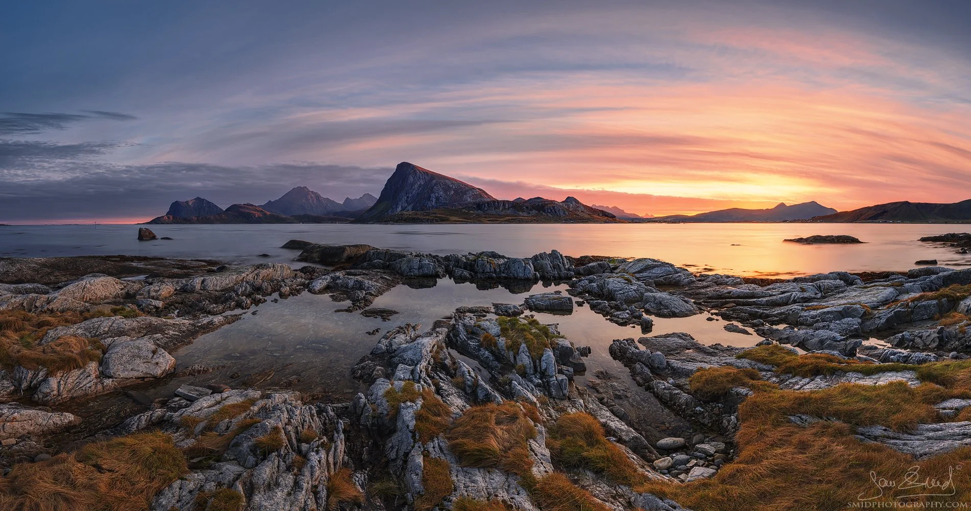 Panoramic landscape photograph "Arctic Autumn" capturing the vibrant sunrise light and coastal reflections in the Lofoten Islands. Captured by Jan Smid, Master QEP, in 2021.