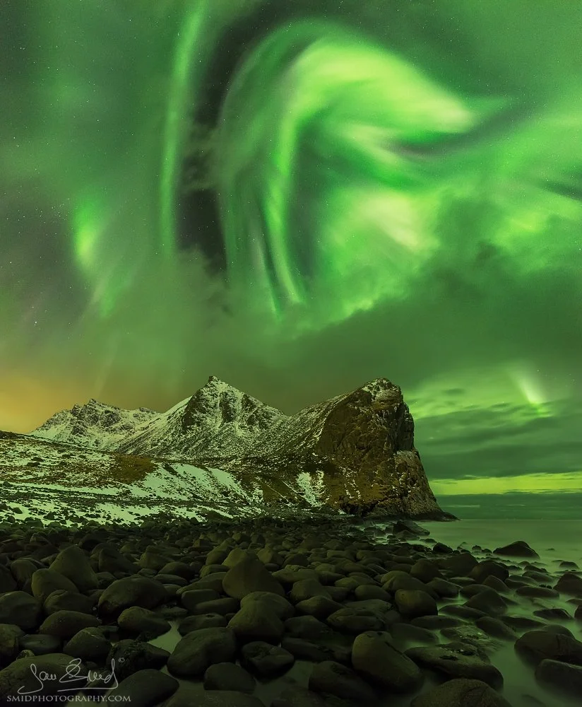 Panoramic night photograph "Trident" featuring the Aurora Borealis over the iconic rock formations at Unstad Beach, Lofoten. Captured by Jan Smid, Master QEP, in 2017.