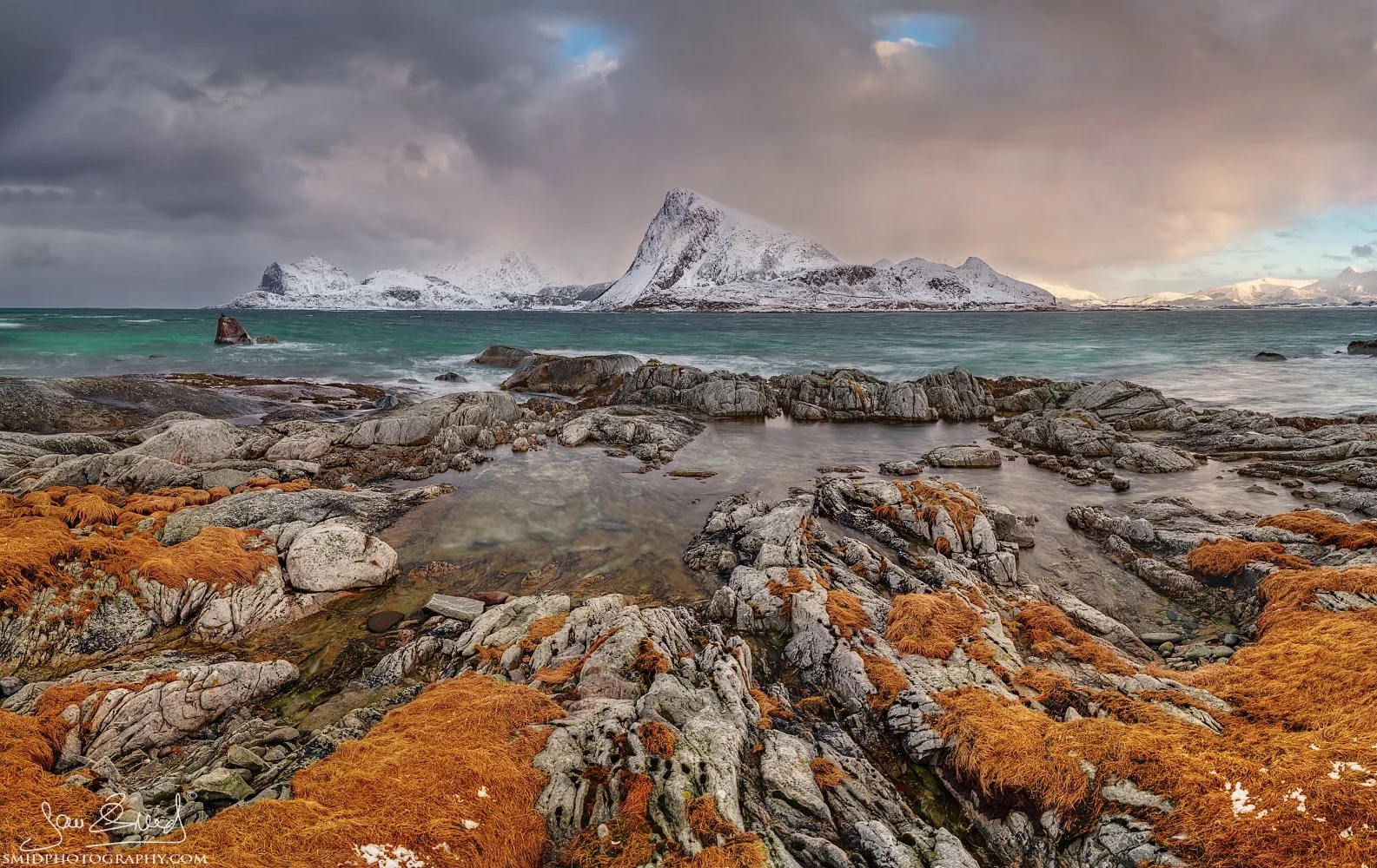 Multi-award-winning panoramic seascape "God's Eyes" featuring unique ice and sand formations on a winter beach in Lofoten. Captured by Jan Smid, Master QEP, in 2020.