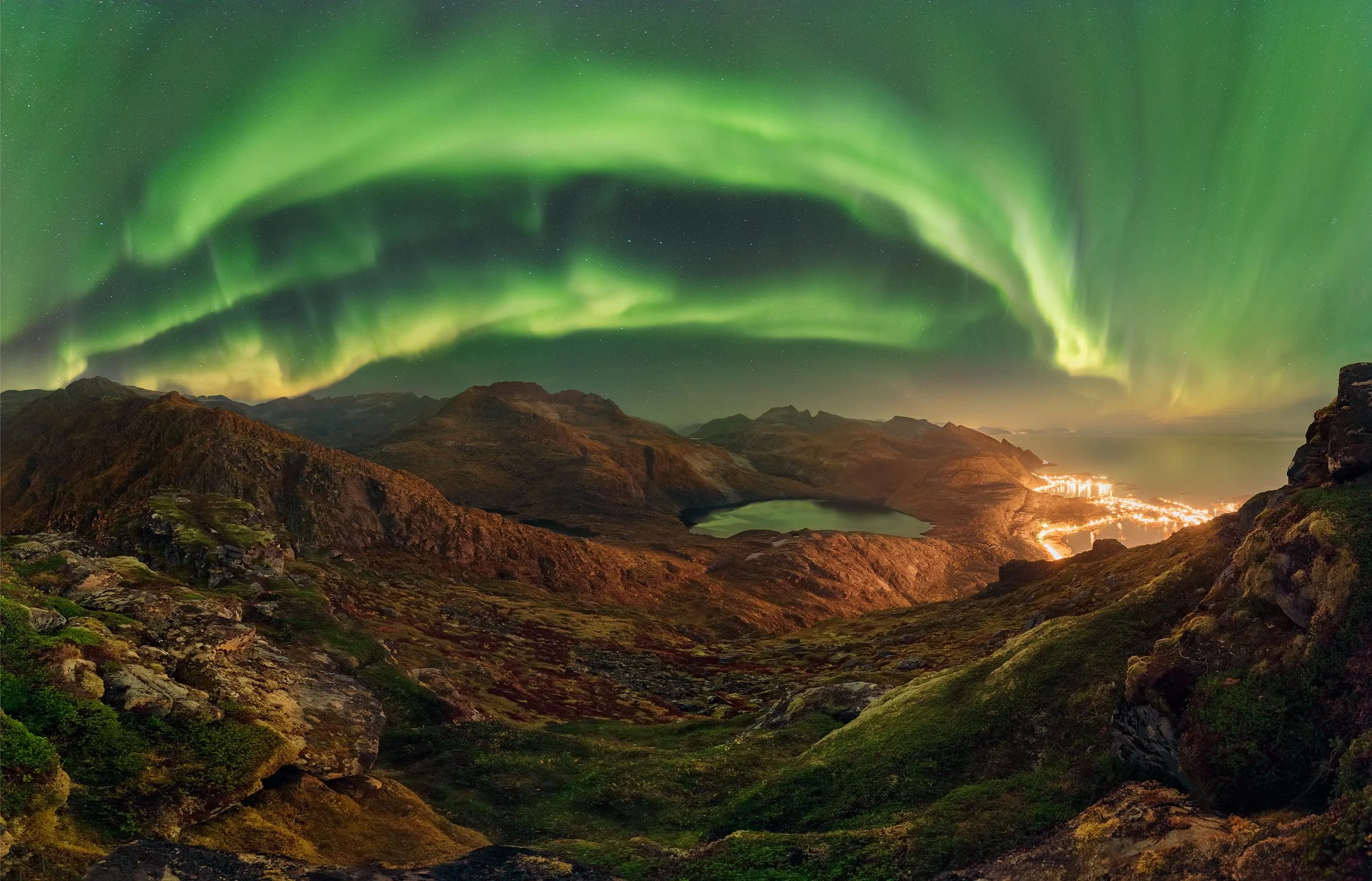Award-winning fine art photography of a massive Aurora Borealis arch dancing over a mountain panorama, captured by Jan Smid, Master QEP, from the summit of Tinstinden during a professional photography expedition in the Lofoten Islands, Norway.
