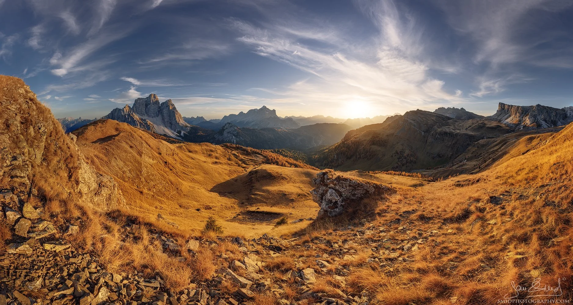 Wide backlit panorama of Dolomites during golden hour sunset, featuring golden grasses and peaks from Pelmo to Mondeval, captured on Dolomites photo expedition with Jan Šmíd, Master QEP
