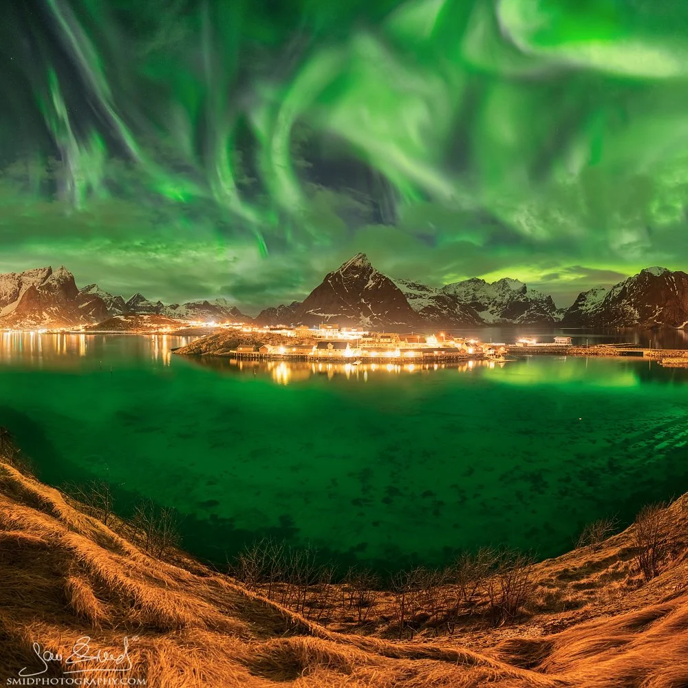 Award-winning night panorama of the aurora borealis over Reine, Lofoten Islands, captured during the February photo expedition to Norway and awarded Gold at Moscow International Foto Awards 2019