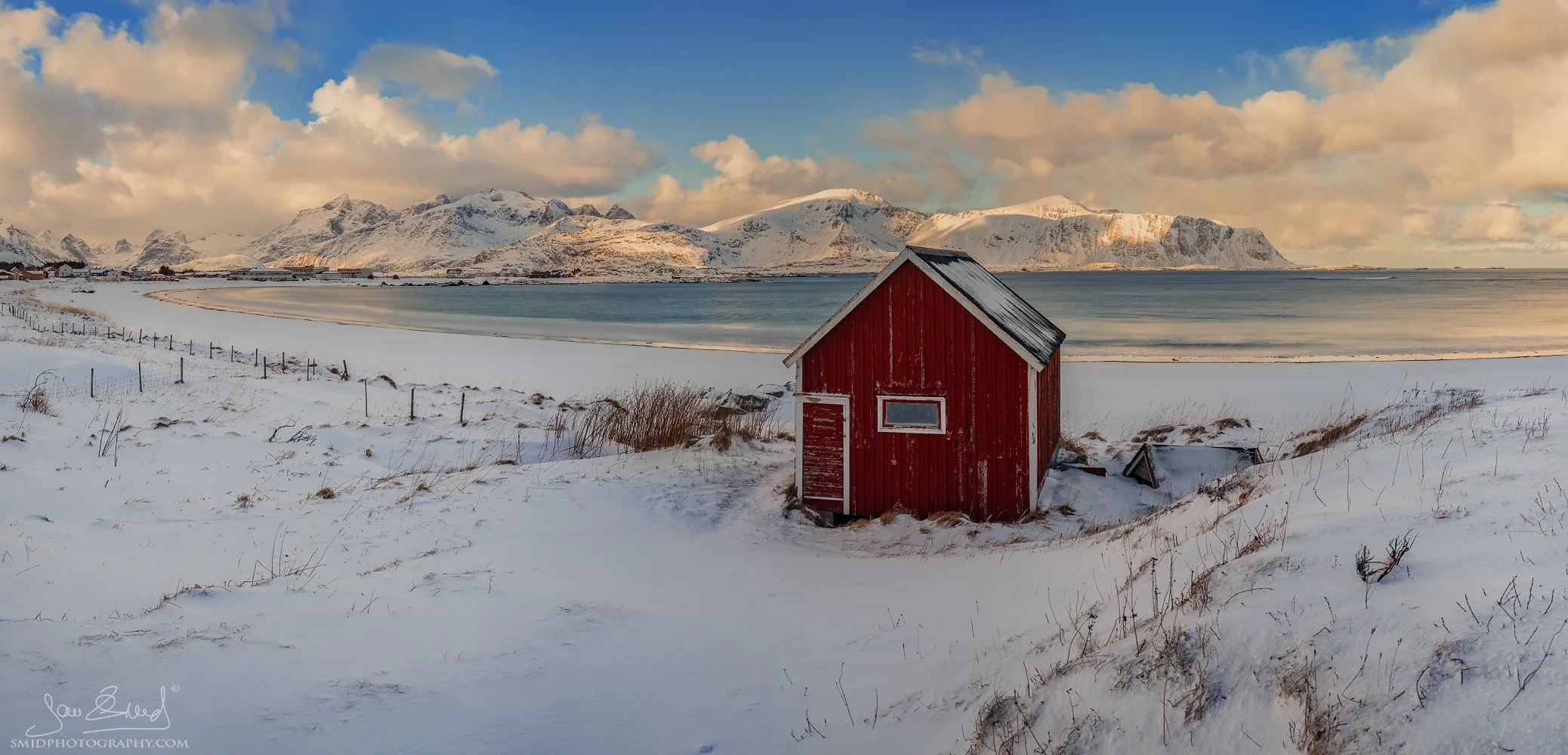 Panoramic landscape photograph "Hilton after the Season" featuring the iconic red cabin at Ramberg beach, Lofoten. Captured by Jan Smid, Master QEP, in 2018.
