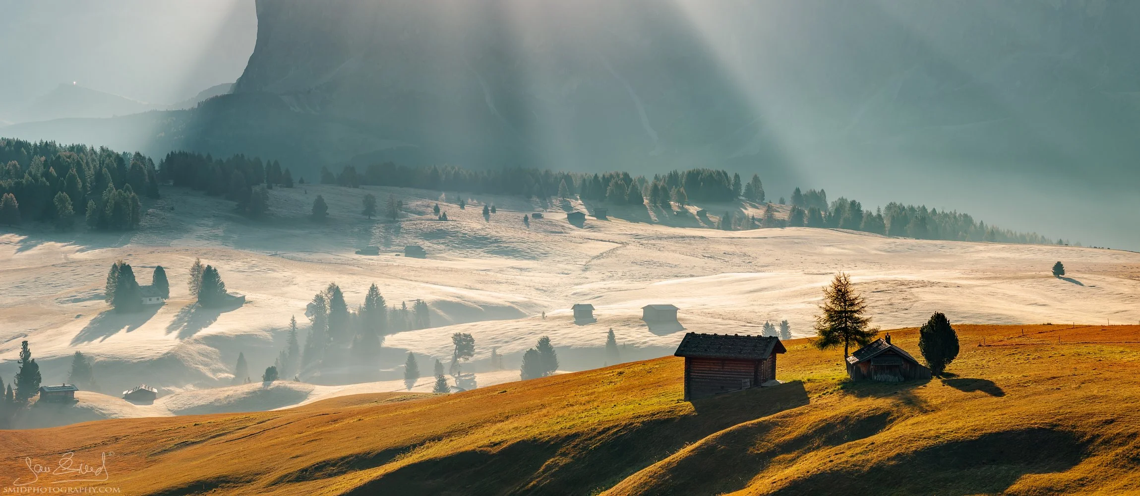 Autumn panorama of mountain huts in Alpe di Siusi under the sun rays, titled Cottages under the Mountains, by Jan Smid, Master QEP.