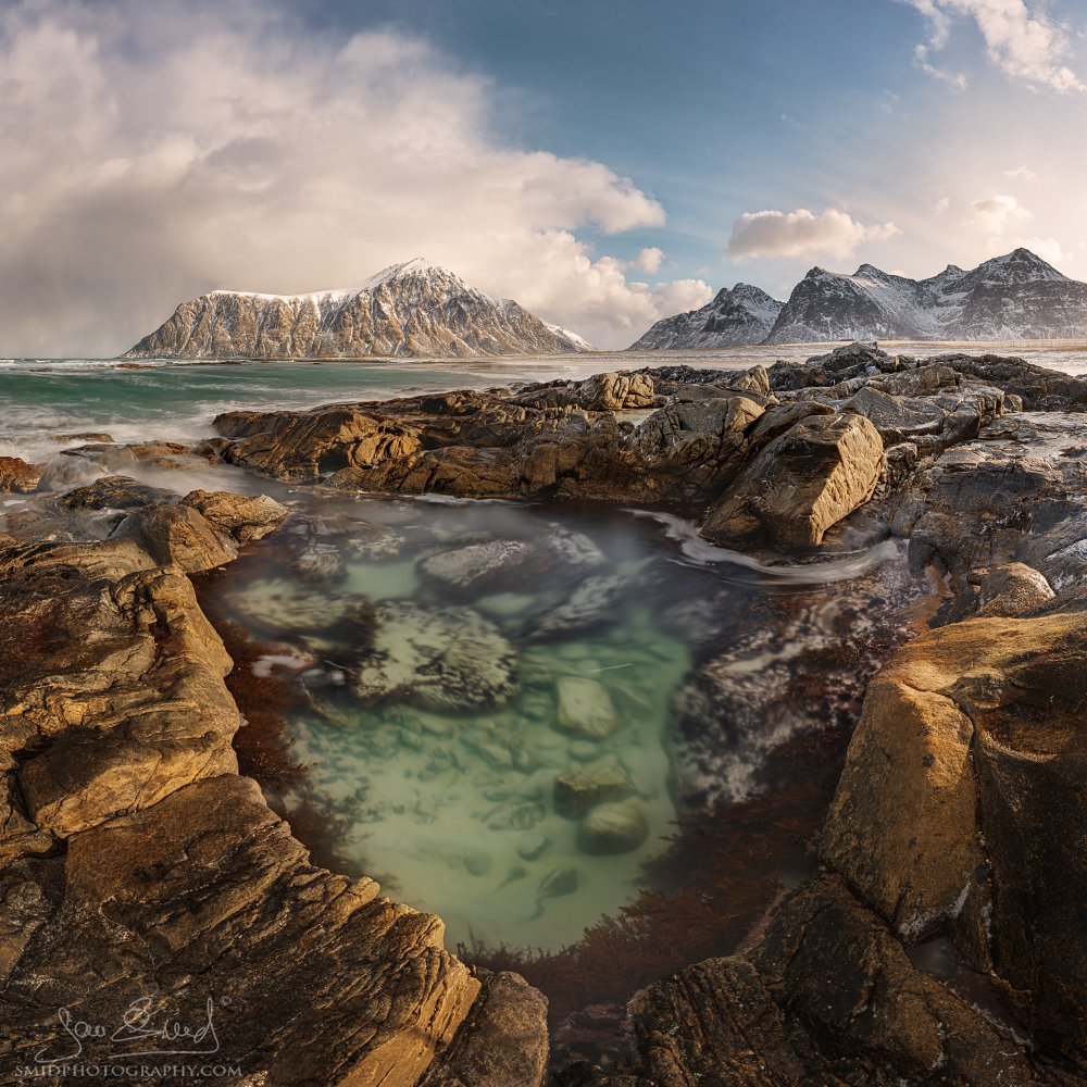 Panoramic photo of Skagsanden Beach in Lofoten, Norway, with beautiful light and dramatic sky, captured during a photo expedition by Jan Smid, Master QEP.