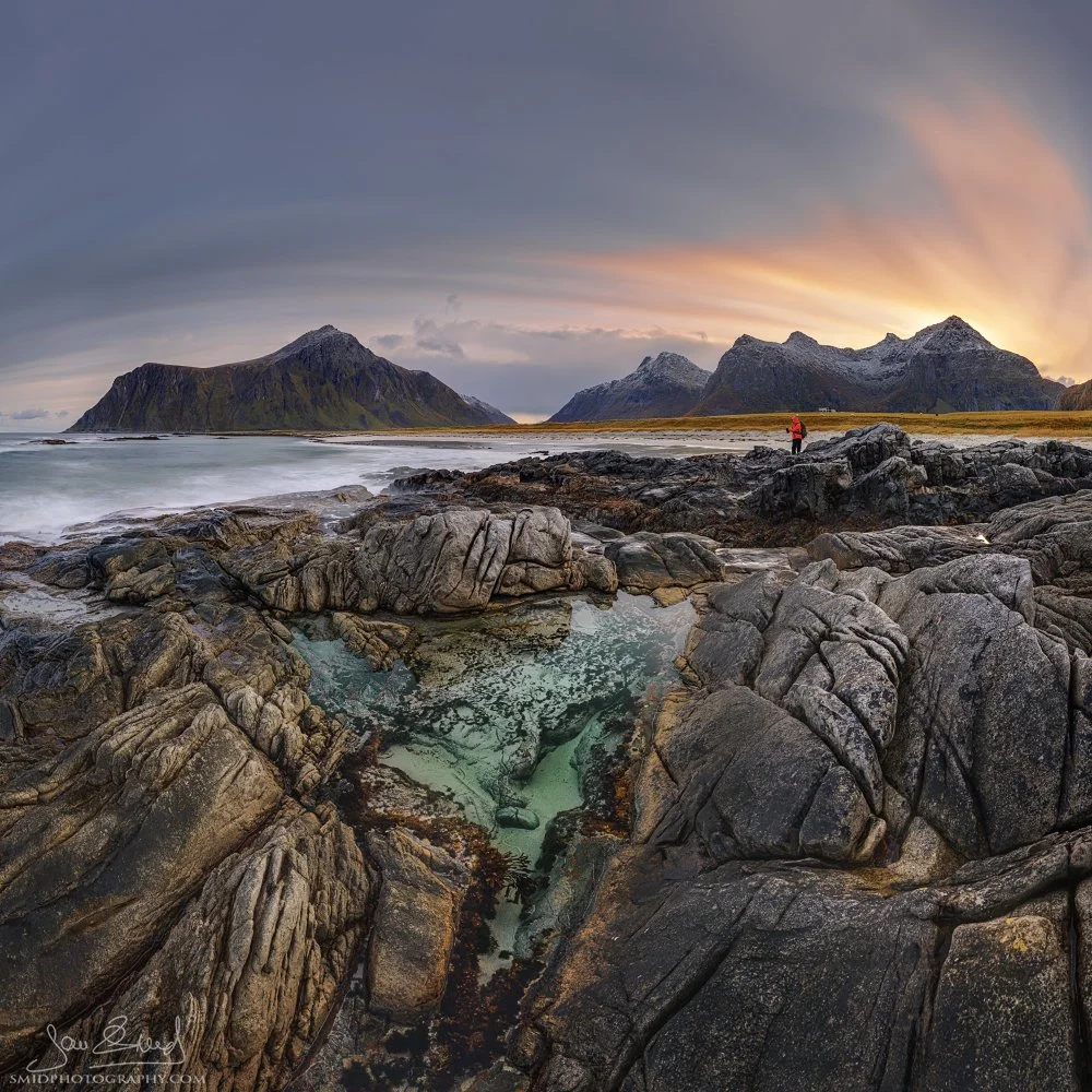 Square panoramic photo of Skagsanden Beach in autumn with colorful pools and a person in a red jacket, captured during a Lofoten photo expedition by Jan Smid, Master QEP.