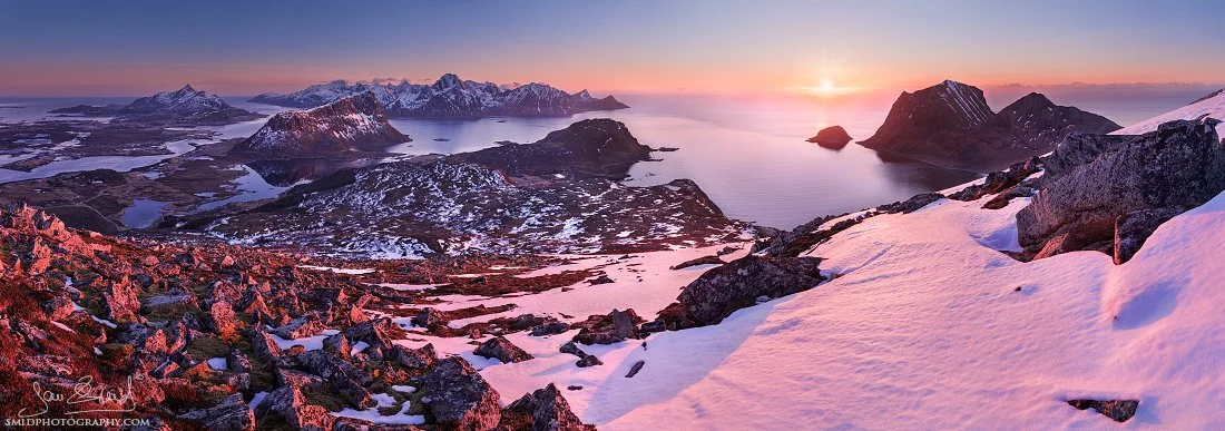 Snowy peaks glowing under Arctic twilight — vast multi-row panorama shot beyond the Arctic Circle in Lofoten (Norsko fotoworkshop).