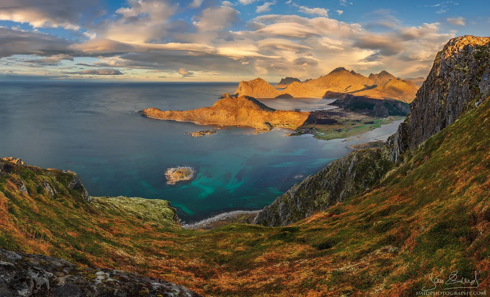 High-altitude panoramic photograph "Turquoise Bay" overlooking the crystal-clear waters and white sands of the Lofoten coastline. Captured by Jan Smid, Master QEP, in 2018.