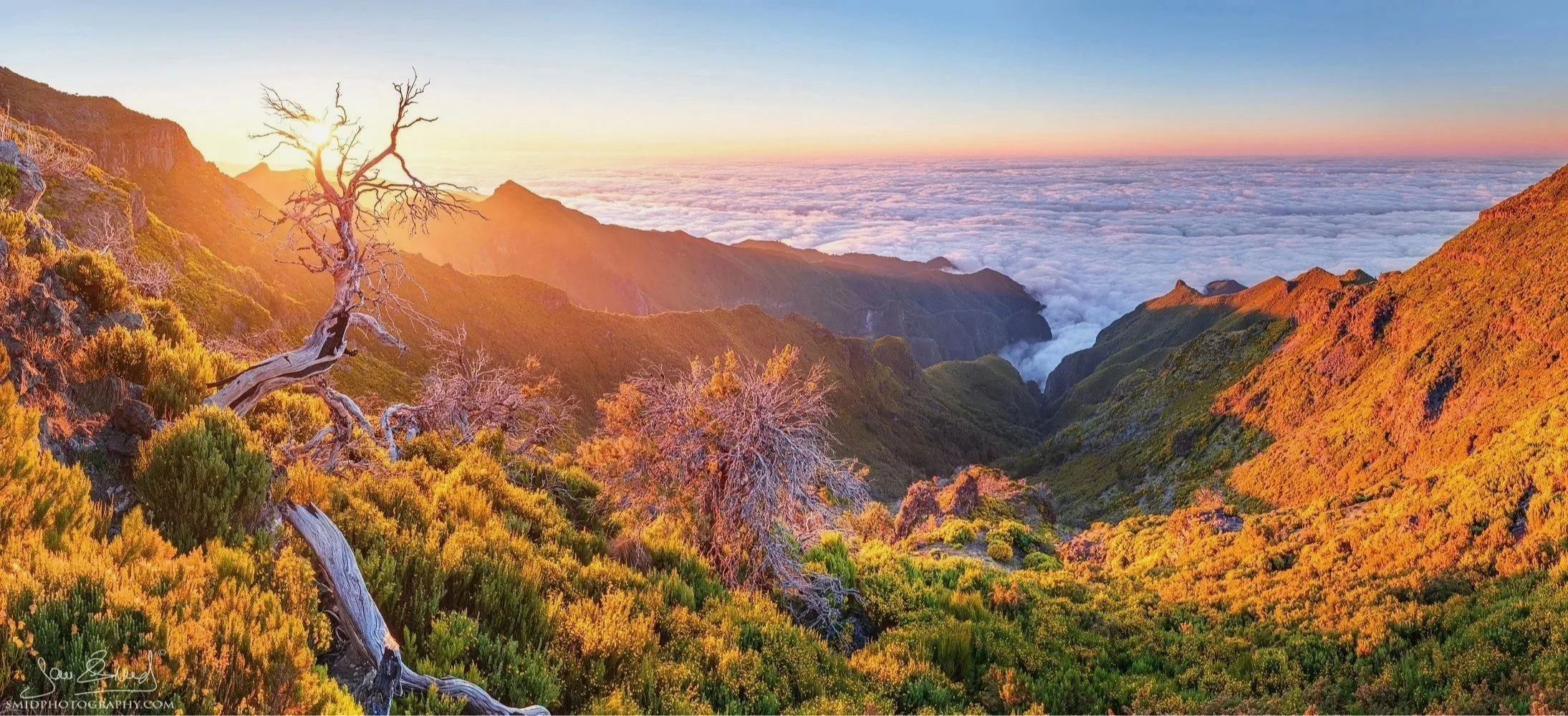 A panoramic sunset view over the clouds from a trail near Pico Ruivo, Madeira, captured during Jan Smid's landscape photography expedition.