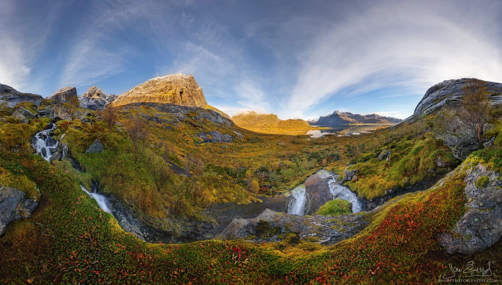 A breathtaking 360-degree autumn panorama titled "Whispers of Autumn" showcasing a hidden valley and cascading waterfalls in the Lofoten Islands. Captured by Jan Smid, Master QEP, in 2024.
