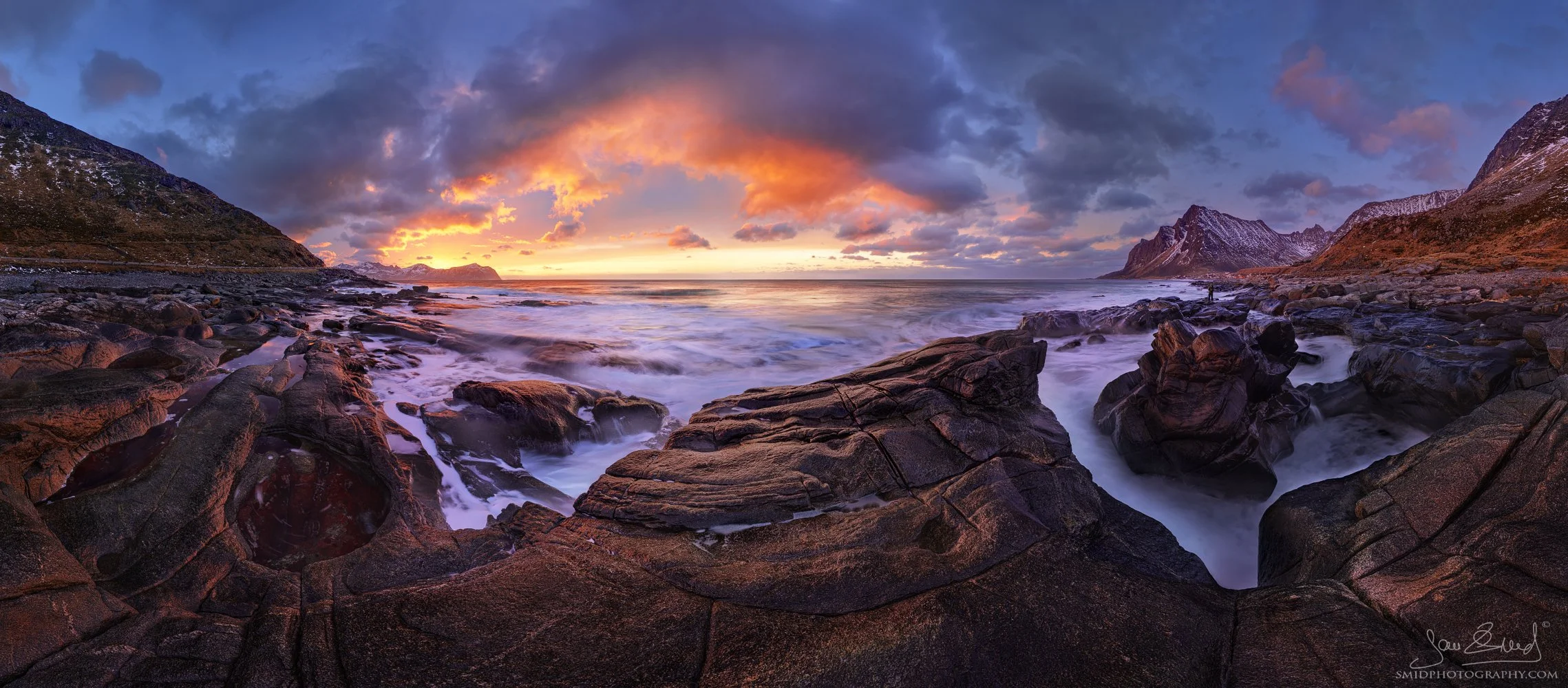Dramatic winter seascape panorama with red and yellow sunset clouds, photographed during day one of the February 2025 Lofoten photo expedition by Jan Smid, using multi-row exposure bracketing
