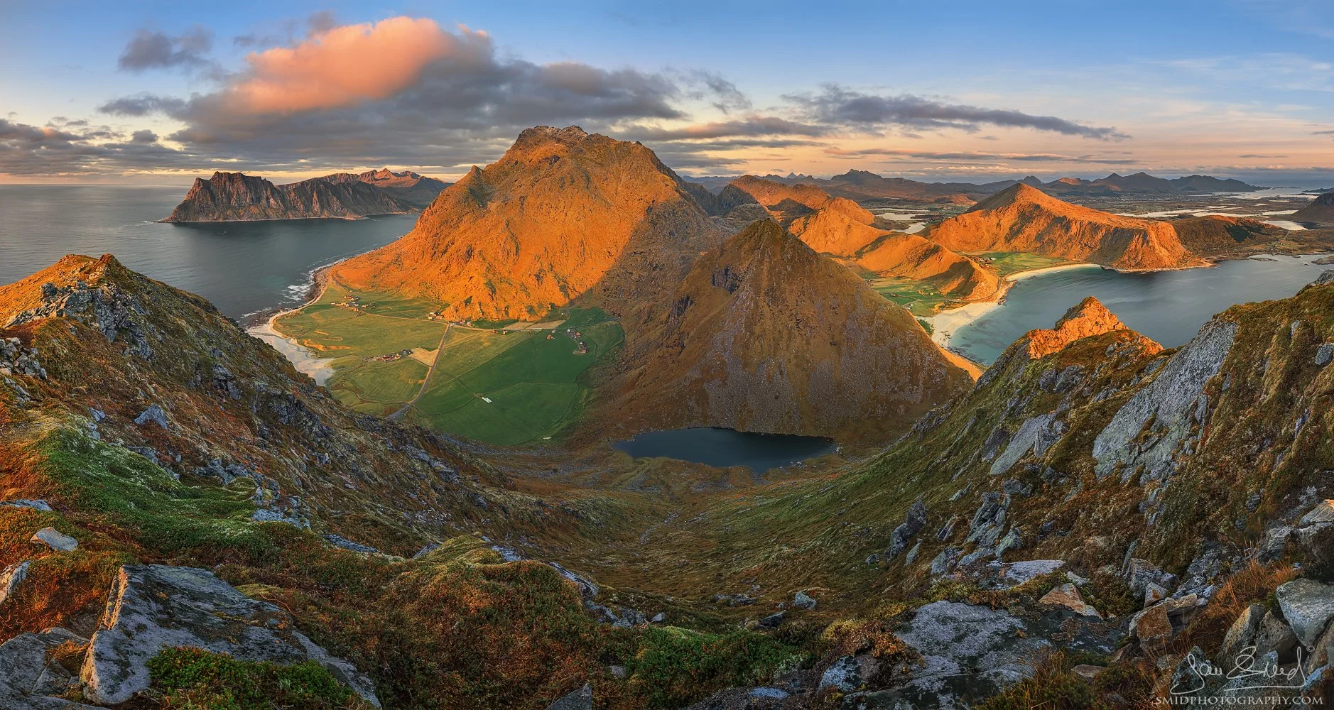 Panoramic landscape photograph "The Last Moment" captured from the summit of Veggen, showing the final golden sunset light hitting the arctic peaks of Lofoten. Captured by Jan Smid, Master QEP, in 2020.