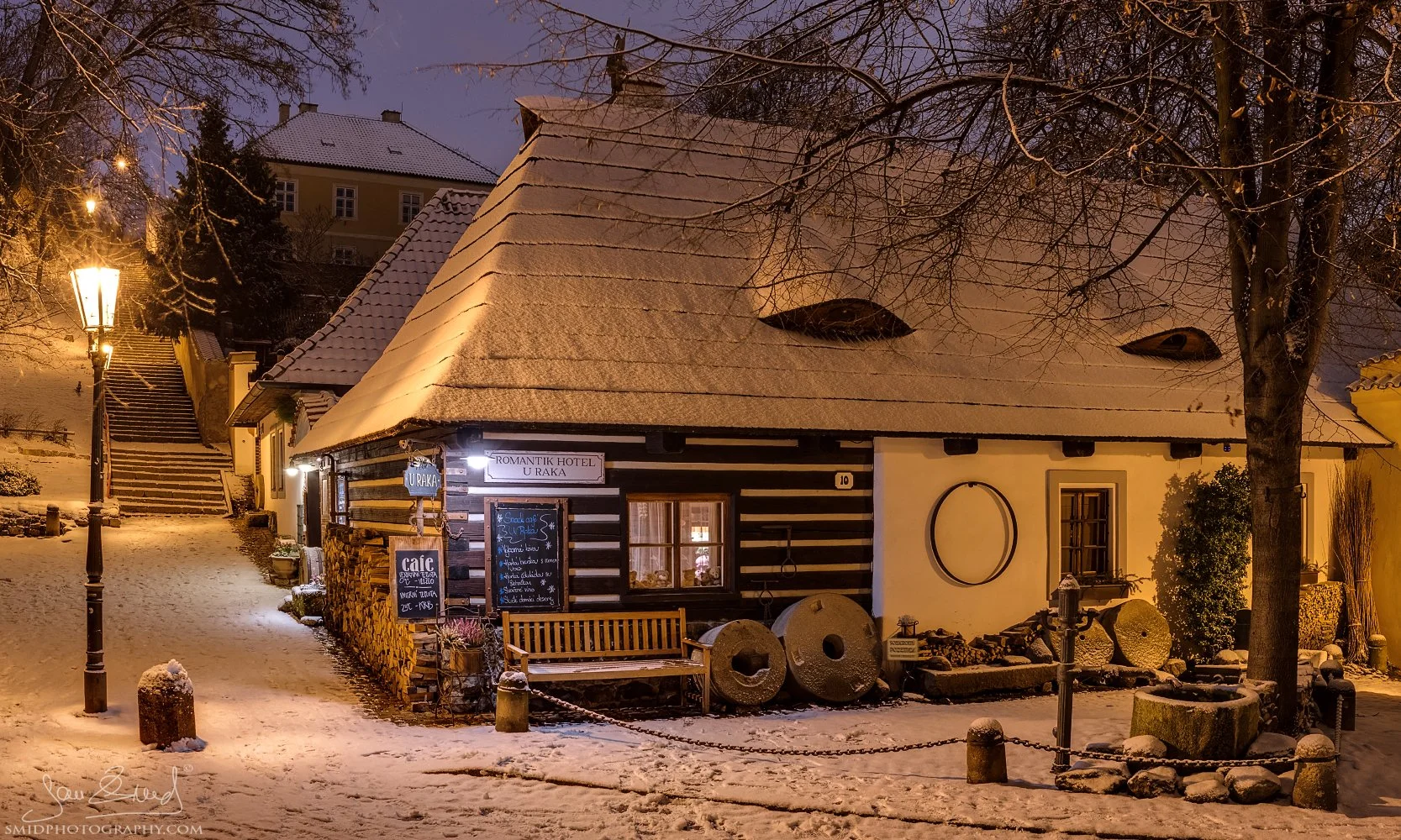 Fine art photography titled "Idyllic Countryside." A picturesque historic timber cottage in the Nový Svět district of Prague, Hradčany. Captured by Jan Smid, Master QEP, in 2019. Rural atmosphere in the heart of the city.